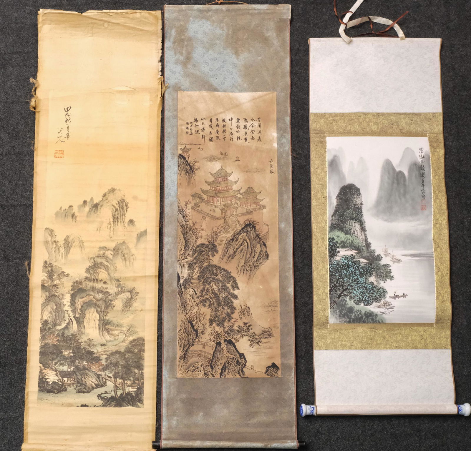 Three Antique Chinese Scrolls: Hand-decorated with landscapes and metallic textiles, one with porcelain weight. All signed with poetic verse. Measuring from:19 1/2" x 46" to 16" x 54 1/2"