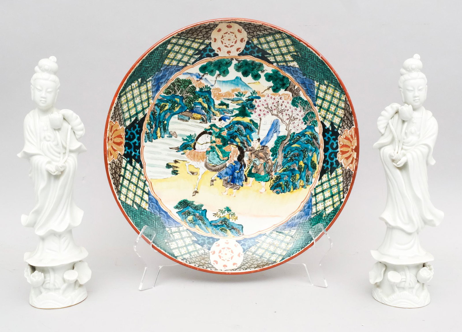 Pair of Blanc De Chine Figures & A Chinese Charger: The Blanc de Chine figurines depicting Quan Yin, together with a porcelain charger with a red signature seal. Plate measures 13" X 2 1/4", figures measure 2 3/4" X 12".