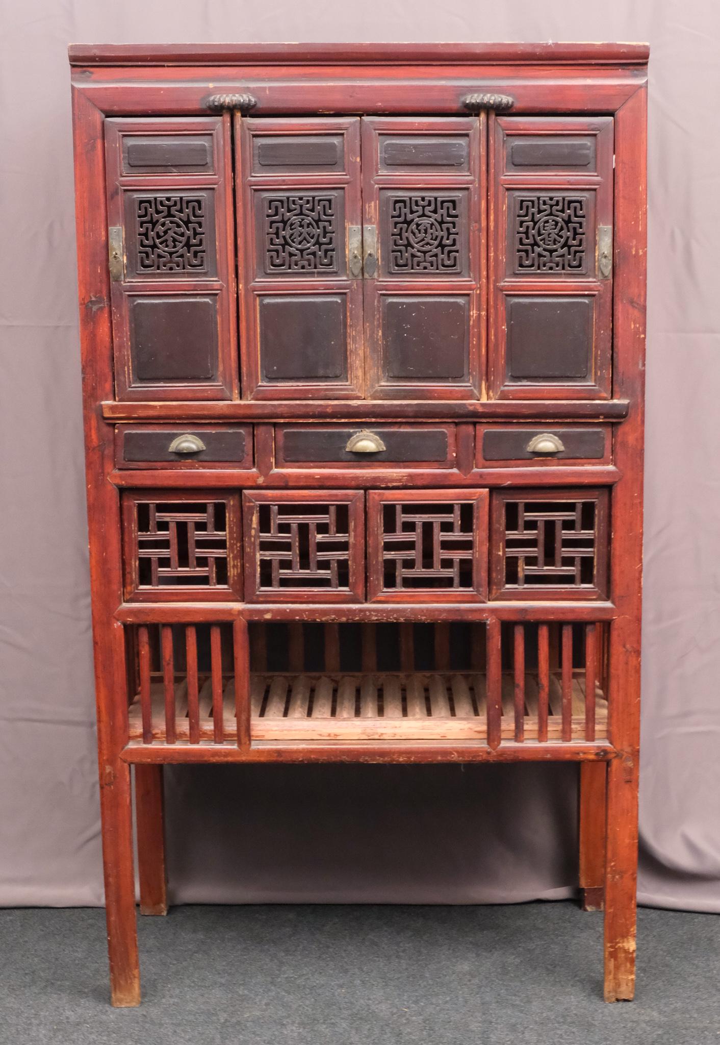 Antique Chinese Rosewood Cabinet: Featuring four pierced doors, decorated in Chinese character seals, with three mid-drawers, and four sliding doors at bottom. Measuring: 40 1/2" x 19" x 71 1/2".