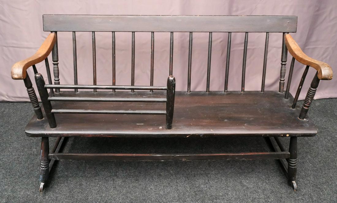 Antique Painted American Bench Rocker: Black painted with red under stain, scrolling arms, and removable railing. 50" wide x 28 1/2" tall x 28" deep.