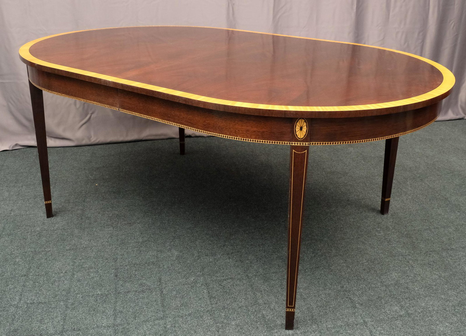 Stickley Hepplewhite Style Dining Table: Hampton finish, with banded inlay skirt, and inlaid legs, with two original Stickley leaves. Marked as shown. Measuring: 72" x 46" x 30" tall. Each leaf 16".