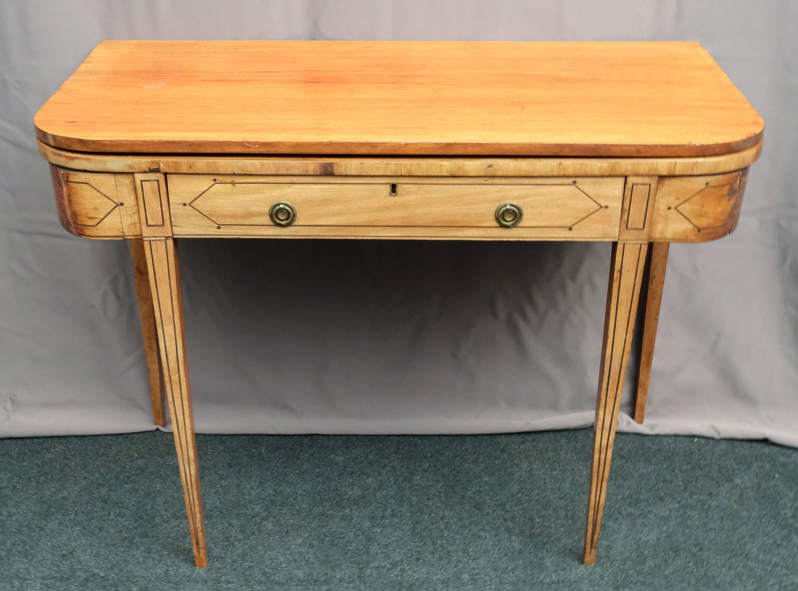 Antique Mahogany Federal Flip-Top Games Table: Likely early nineteenth century, this piece presents quite nicely: mahogany wood with original brass pulls, ebonized inlays, and double gate leg design. Measures 38 1/2" X 19" X 30 1/4" folded, 38 1.2