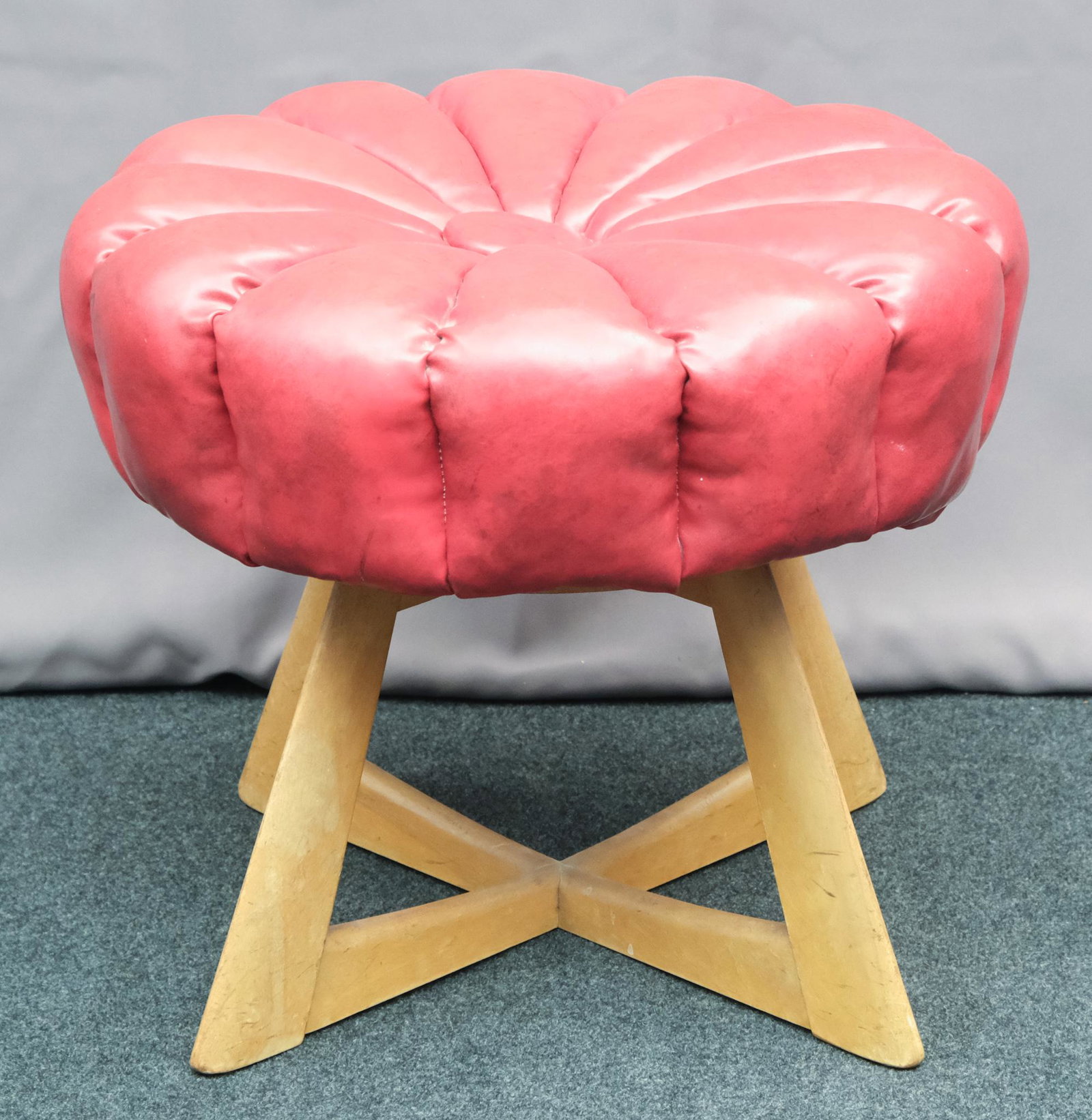 Heywood Wakefield Tufted Red Leather Footstool: Modernist x stretcher. Rotating top with x-stretcher base. Measuring 17 1/4" x 20".