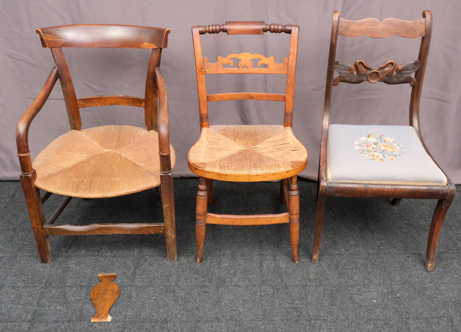 Three Vintage or Antique chairs Chairs: Comprising an oak chair with rush seat. a second rush seat chair (possibly pine), and a drop-seat chair with a lovely stitched floral pattern. Smallest measures 17 1/2" X 15 1/2" X 32", largest measur