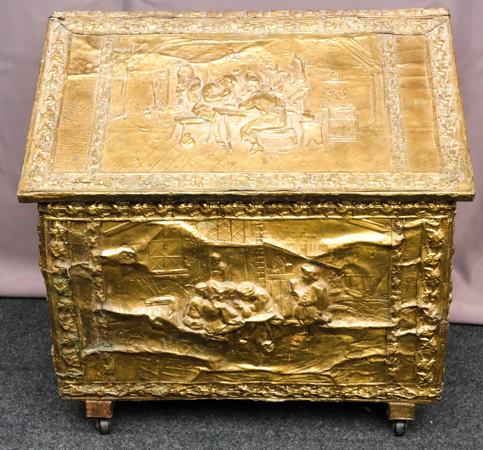 Antique Brass RepoussÃ© Tinderbox: Brass over wood, this tinderbox features a tavern scene on the top and front, and a scene of soldiers or explorers on either side, all bordered by a floral pattern.23" H x 25-1/2" W