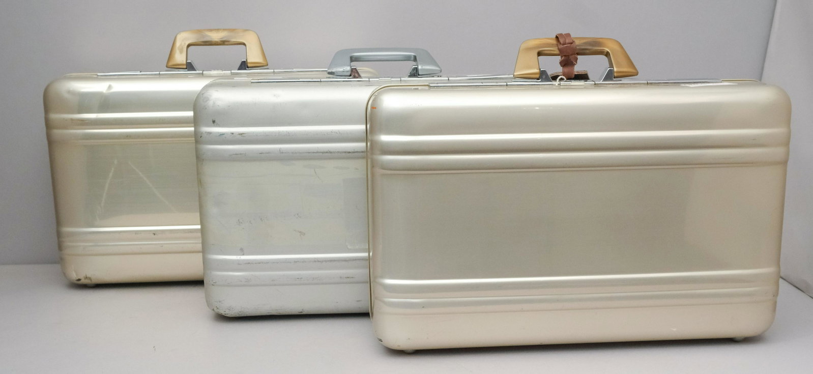 Trio Halliburton Zero Aluminum Suitcases: Sleek and modern. Marked as shown. Measuring: 7" x 14" x 21".