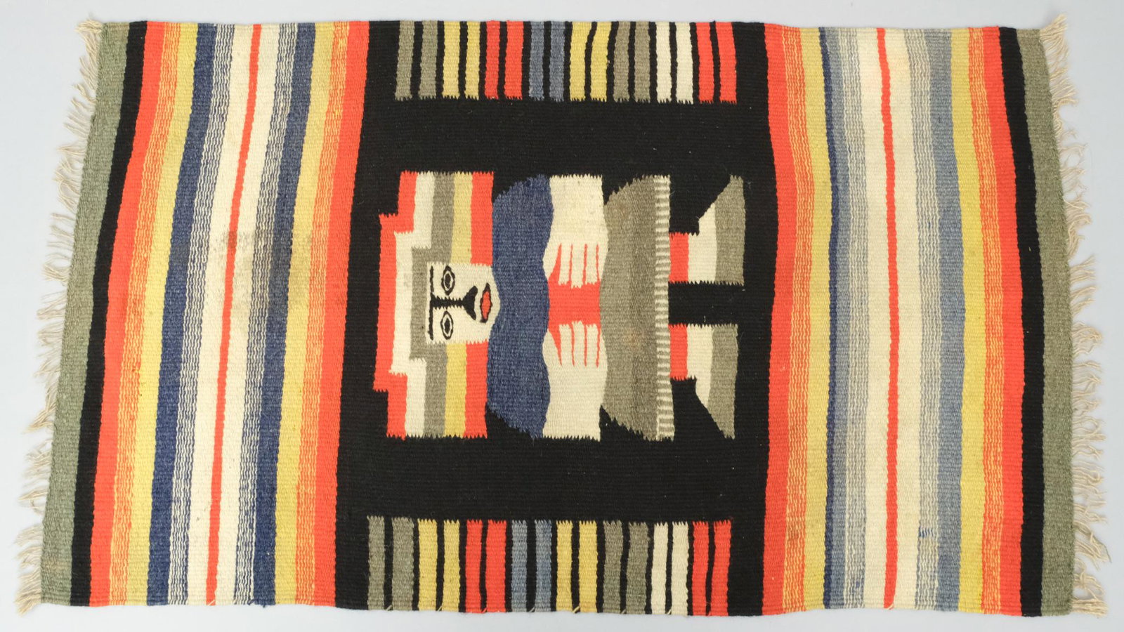 Southwestern or Central American Style Woven Rug: Depicting a Shaman or Holy Man in a rainbow of colors. Measuring 20 1/2" x 33 1/2".