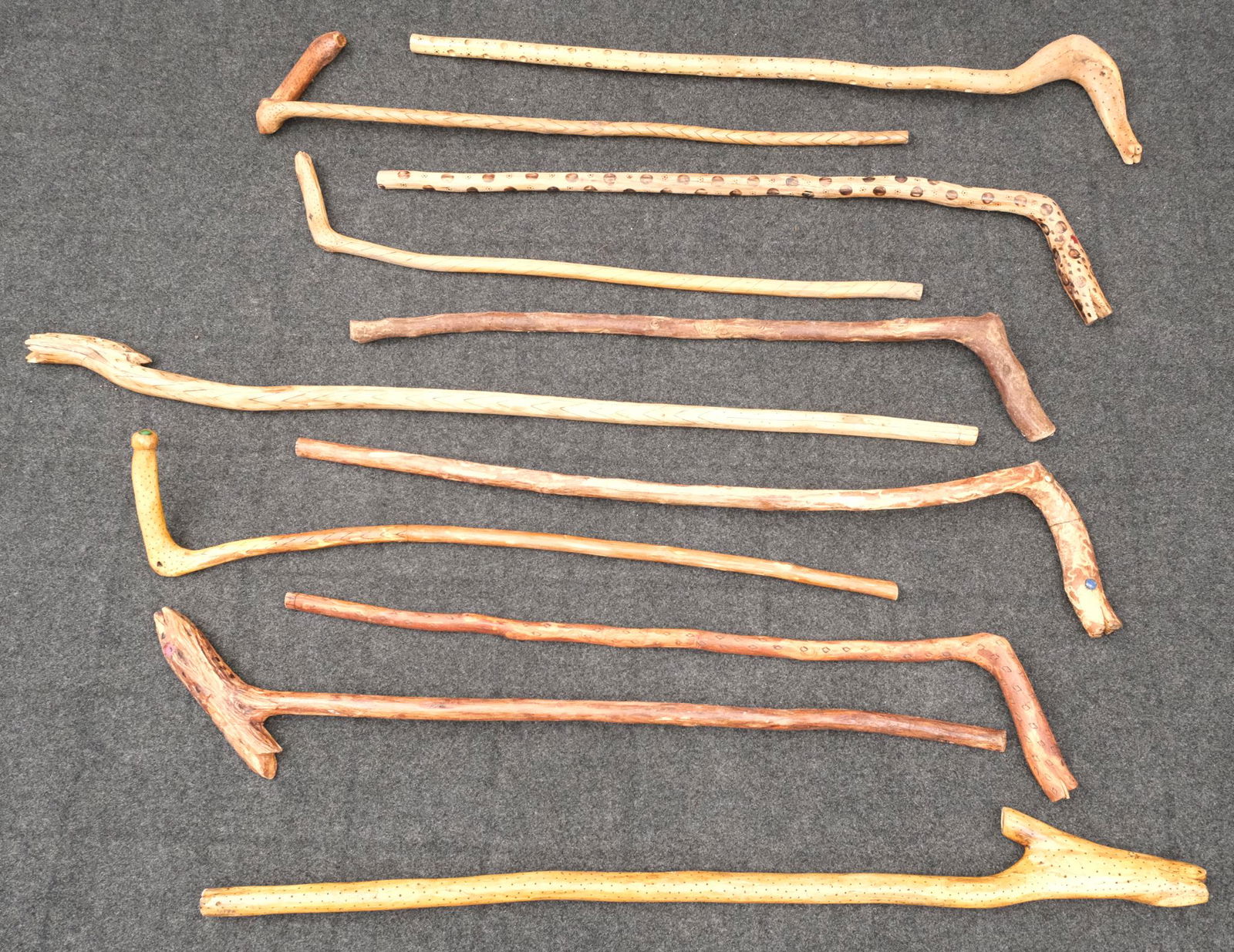 Eleven Walden Macpherson Folk Art Carved Canes: Group of Eleven root art walking sticks, variously decorated with carved and applied elements. Macpherson was an avid woodworker and naturalist who constructed his art using exclusively found and scav