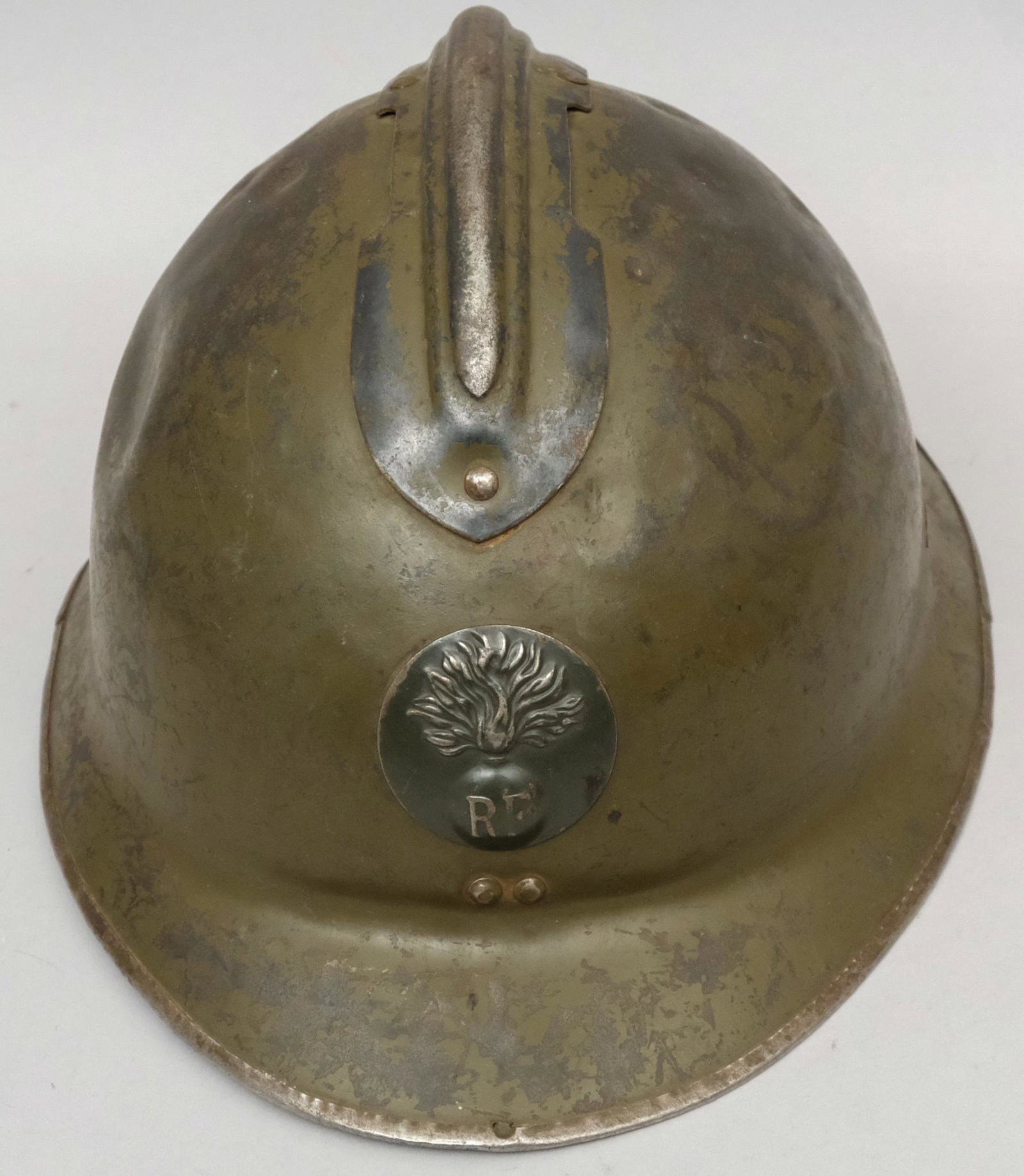 WWI Adrian French Artillery Helmet: Bearing the "RF" insignia under a flaming torch. Measures 6" X 9 1/4" X 12 1/2".