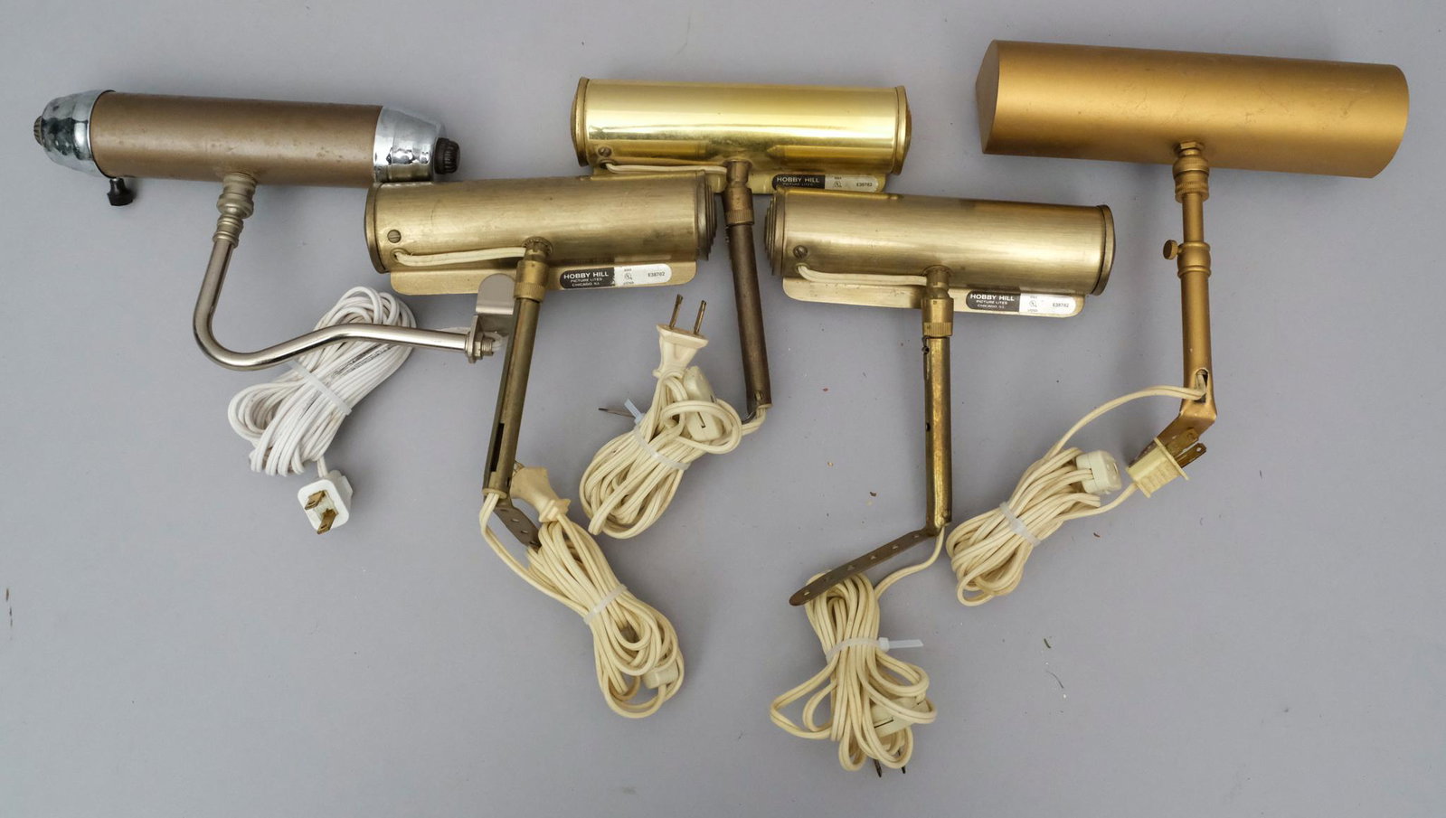5 Frame Mounted Painting Lights 6 1/2" - 8 1/2" L: Brass finish, attached wall mounts, two marked "Hobby Hill Picture Lite" Measuring: three 6 1/2", one 8", one 8 1/2" long.