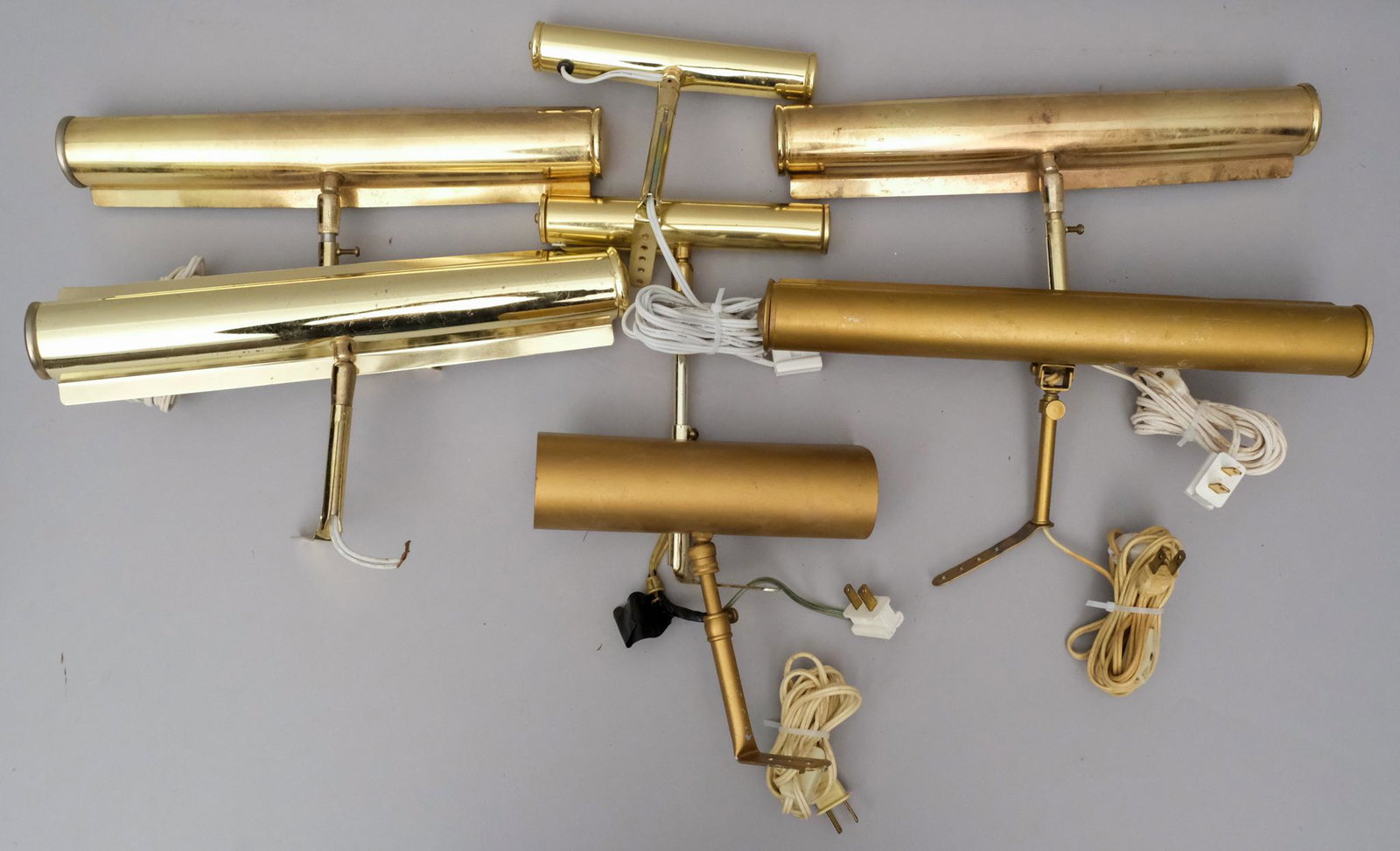 6 Frame Mounted Painting Lights 7 1/2" - 13 1/2" L: Brass finish, attached wall mounts, one lamp marked "Firefly". Measuring: two 7 1/2" and four 13 1/2"