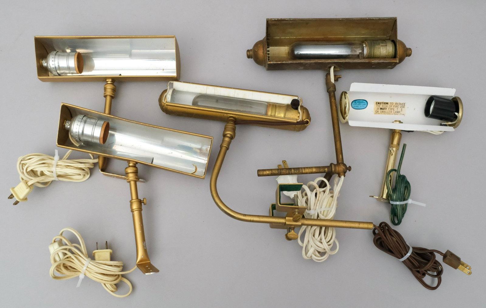 5 Frame Mounted Painting Lights 6 1/2" - 8 1/2" L: Brass finish with attached to wall mount. "Measuring: one 6 1/2" long, one 8" long, three 8 1/2" long.