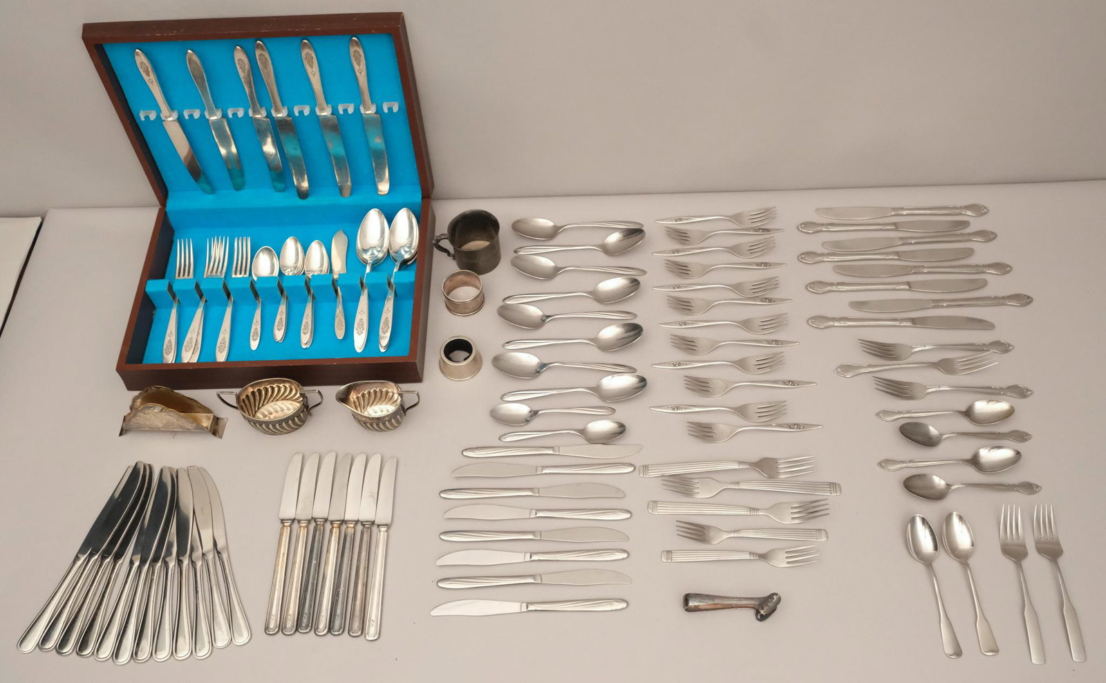 Service of Birds of Paradise Silverplate Flatware: In a fitted case, together with a variety of additional stainless and silverplate serving pieces.