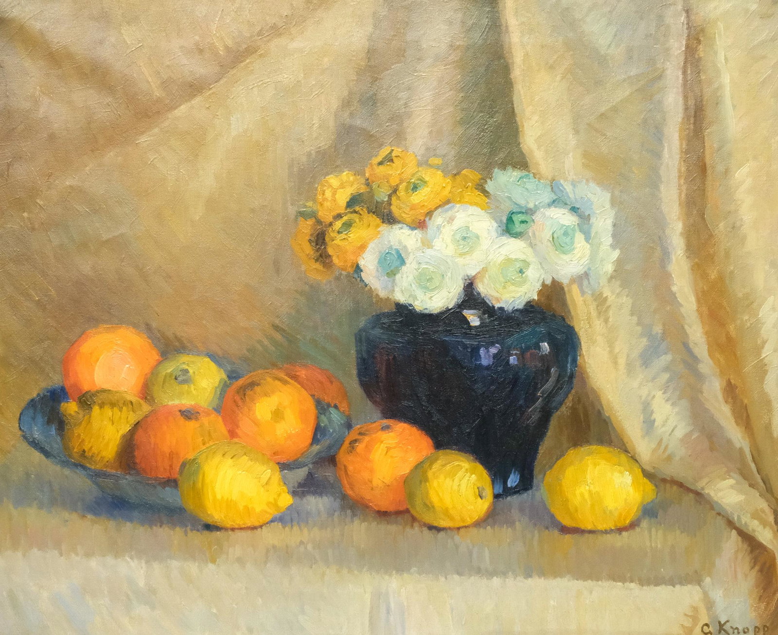 Gertrud Knopp, Still Life with Ranunculus & Citrus: Gertrud Knopp (American, 20th century), oil on canvas depicting a blue vase containing white and gold ranunculus flowers and an overflowing bowl of oranges and lemons in front of a curtain, signed l.r