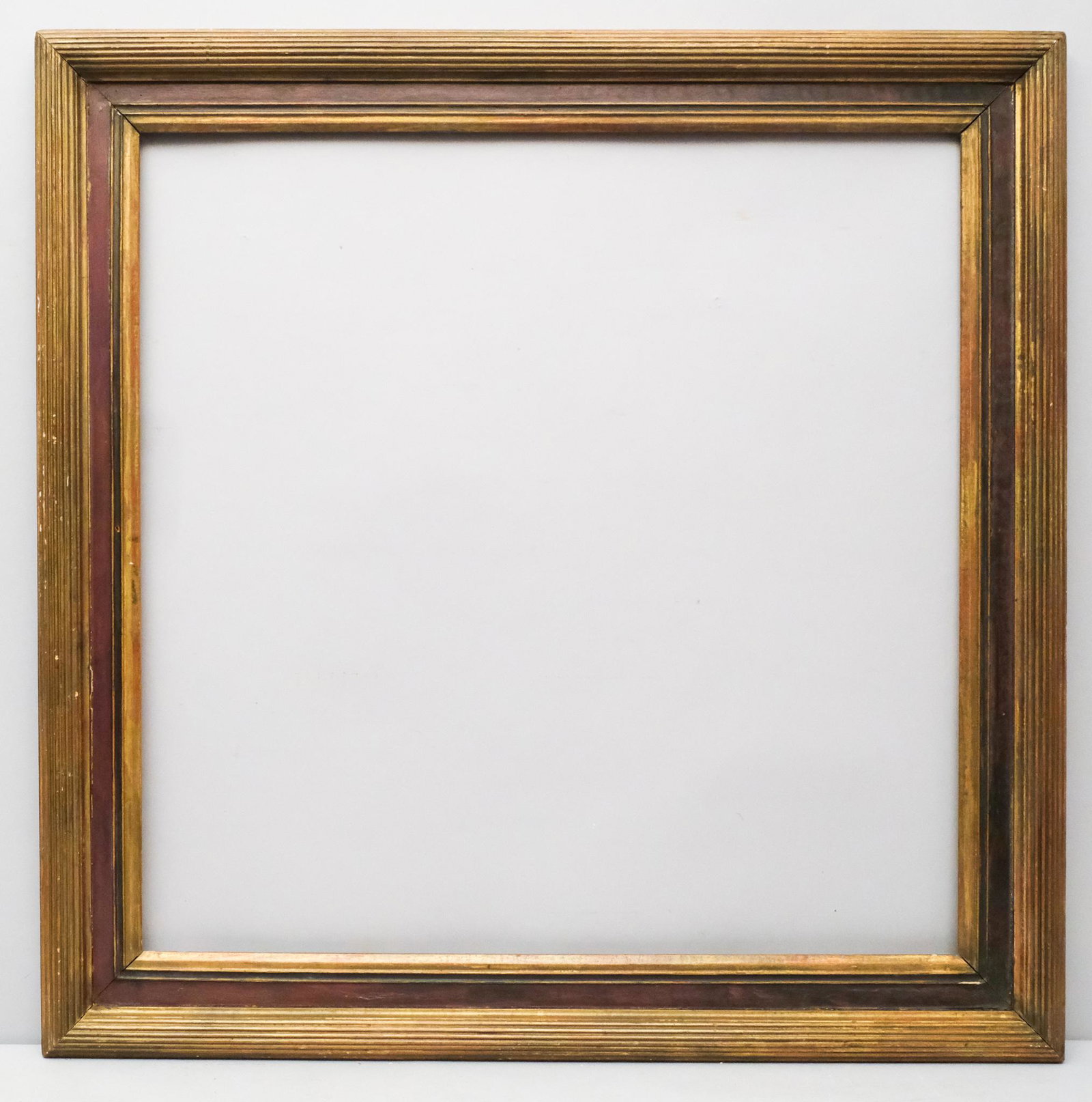 American Whistler Gilt Frame: American, ca. 1900, having complex reeded profile and dark red panel. Rabbet: 30 1/4" X 30 1/4". Overall: 36 3/4" X 37". Molding: 3 1/2".