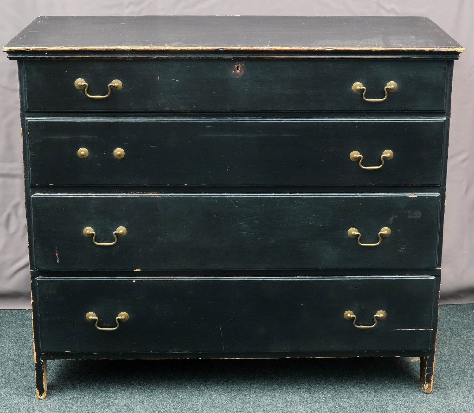 Lift-Top Blanket Chest: Lift-top blanket chest with two working drawers below, one false drawer above, brass pulls, cutout feet, and old black paint. Measures 17" X 38 3/4" X 33 1/2".