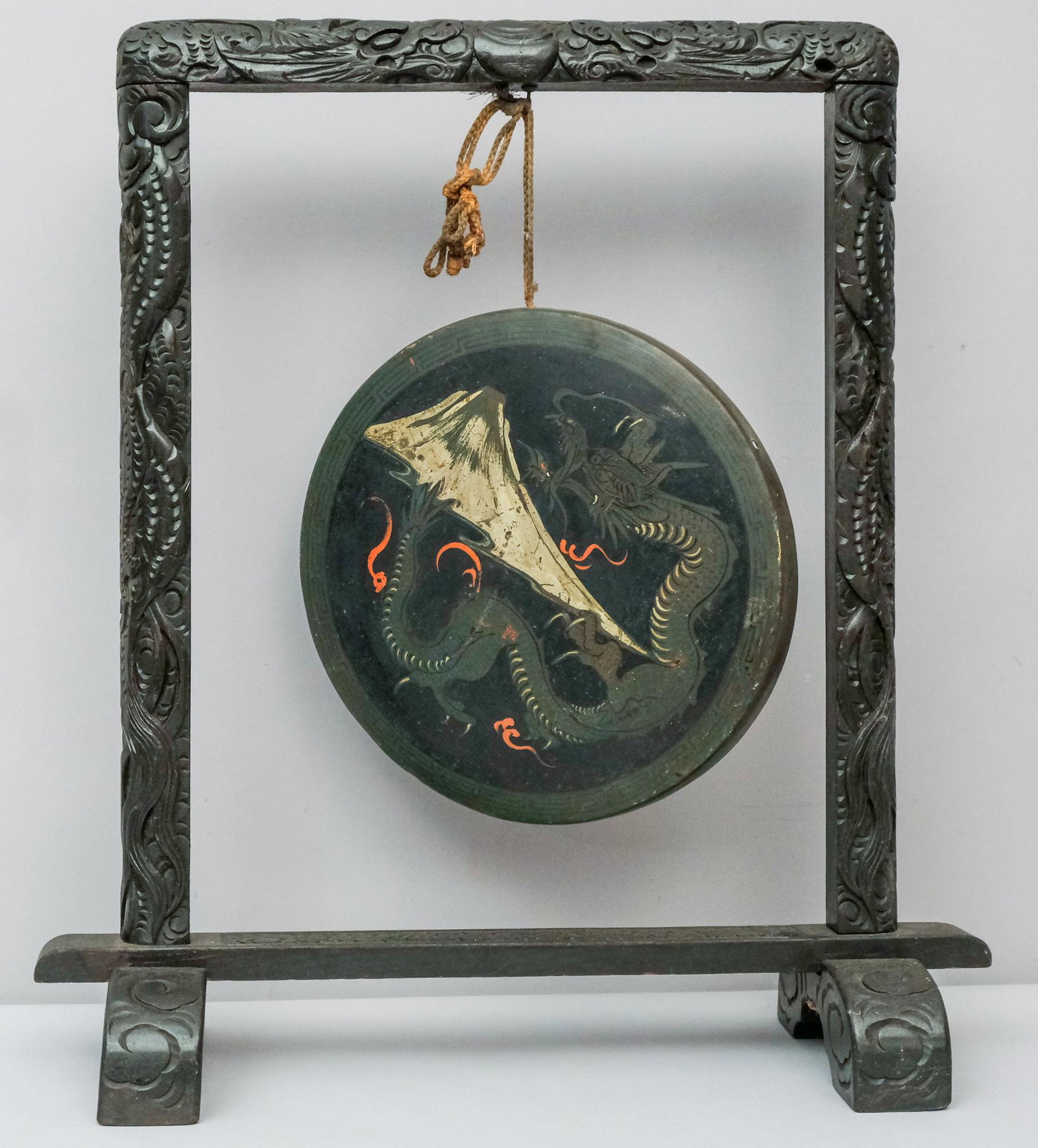Antique Japanese Carved Ebonized Wood Dragon Gong: Extensively carved with dragons and clouds. The gong painted with rising green dragon over Mt. Fuji. stand 8" X 22" X 24", gong 12" diameter.