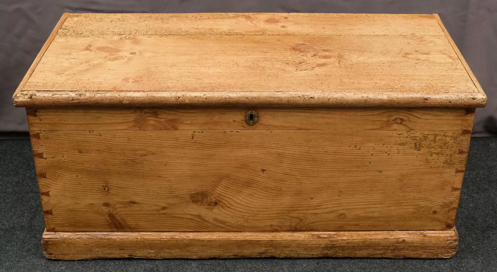 Antique Dovetailed Blanket Chest: With metal handles and dovetailing, possibly Hudson Valley made. Interior till present. Measures 38 1/2" W X 19" D X 17 1/4" H.