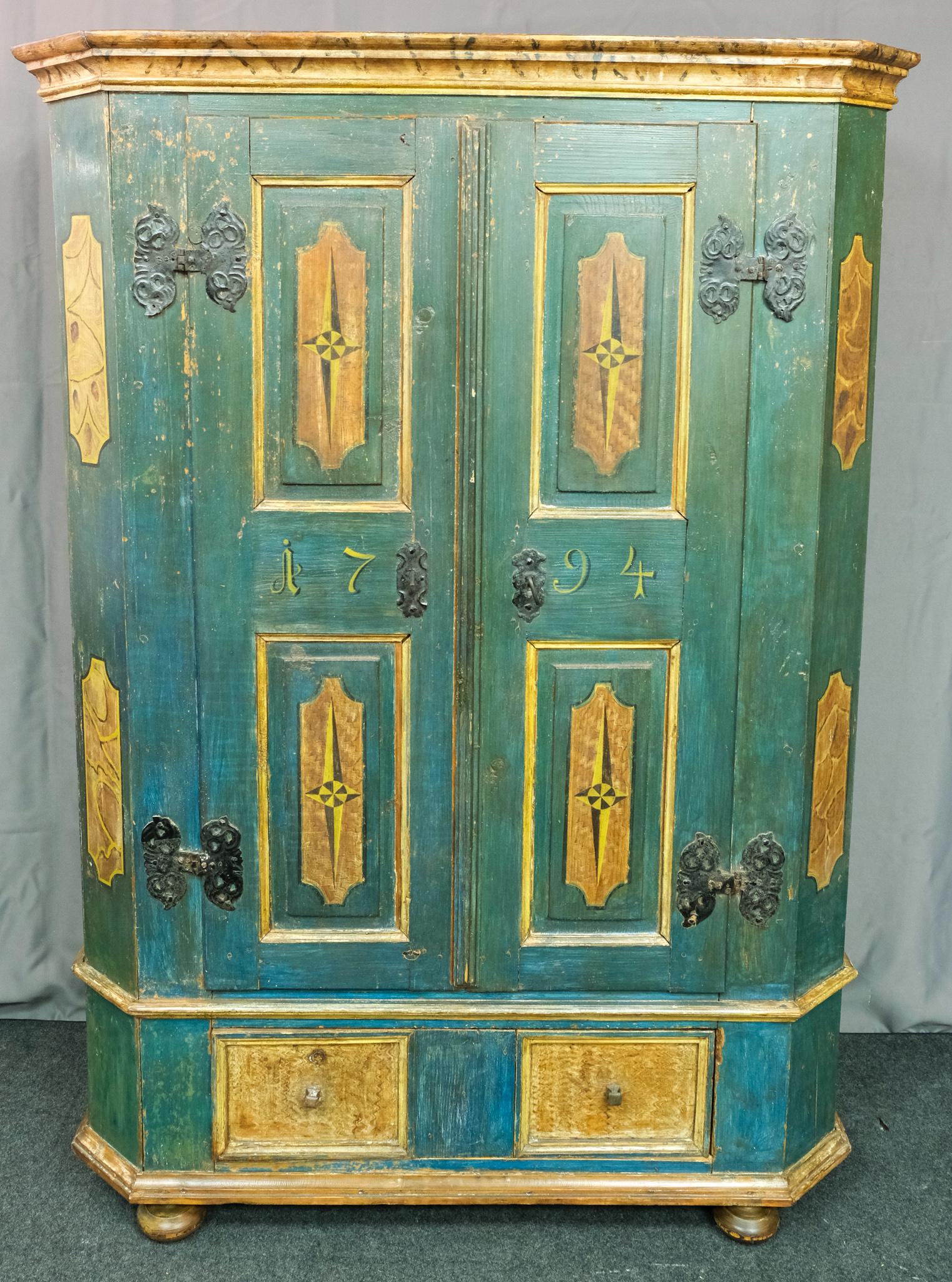 Austrian Painted 1794 Kas Cupboard: With wrought iron hinges and hardware, including oversized key. Comb and faux bois painted cartouche and compass stars. Deep green with chrome yellow accents. Well built body on squashed ball feet. Da