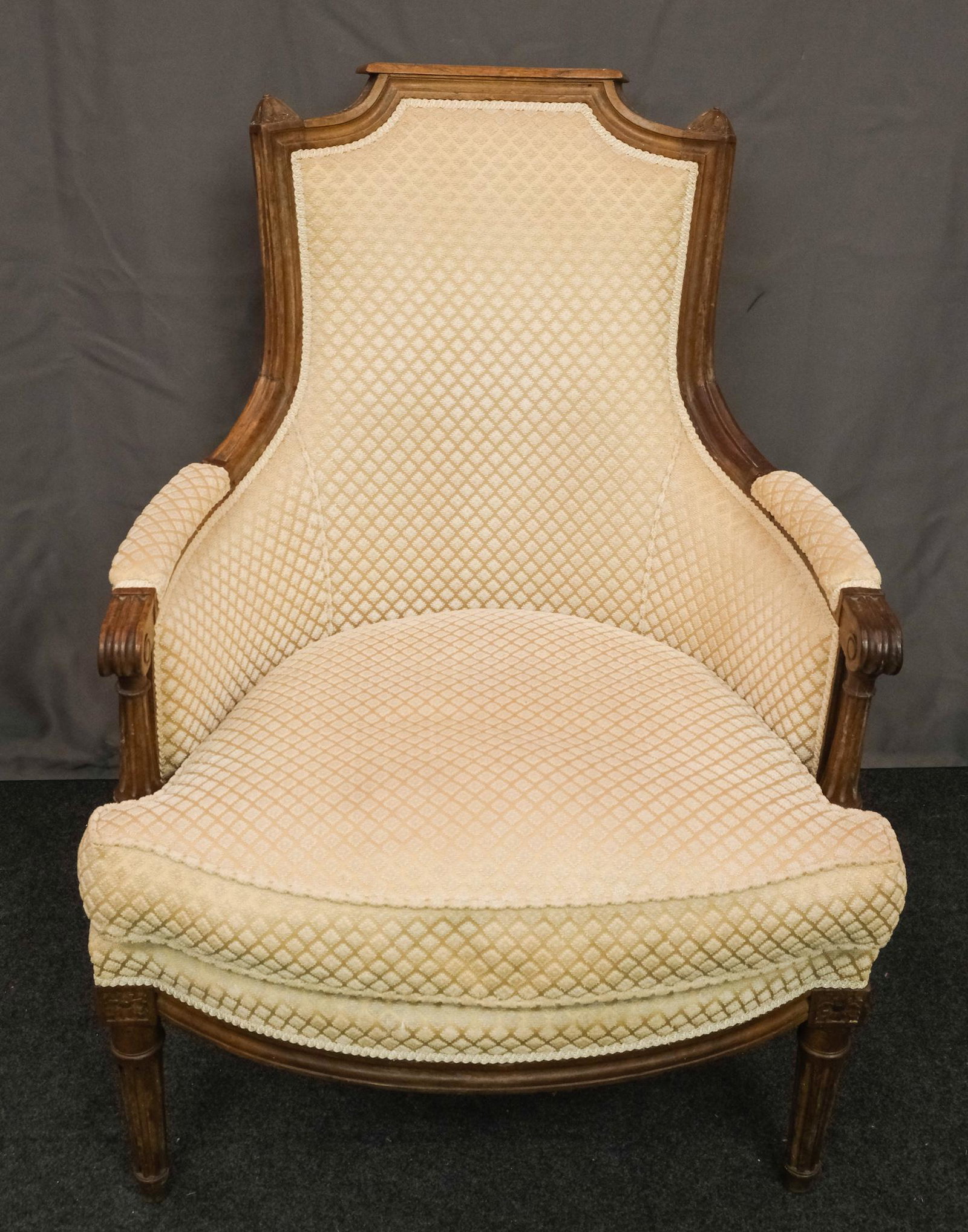 Oscar Shadell Carved Bergere: Oscar Shadell carved bergere with cream colored upholstery in a raised diamond pattern. 26 1/2" W X 29" D X 36 1/2" H