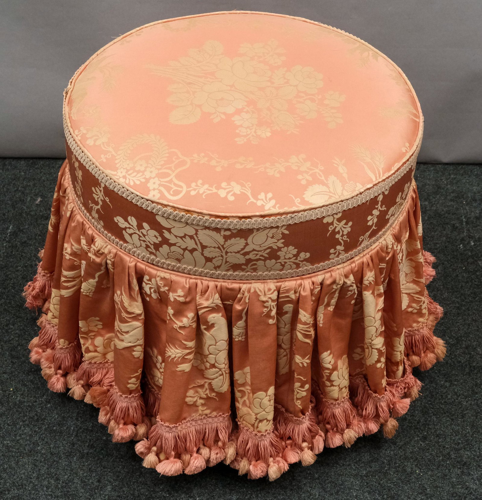 Round Pink Damask Swivel Ottoman: Pink damask swivel ottoman with tasseled trim on skirt. 16" diameter X 14 1/4" H