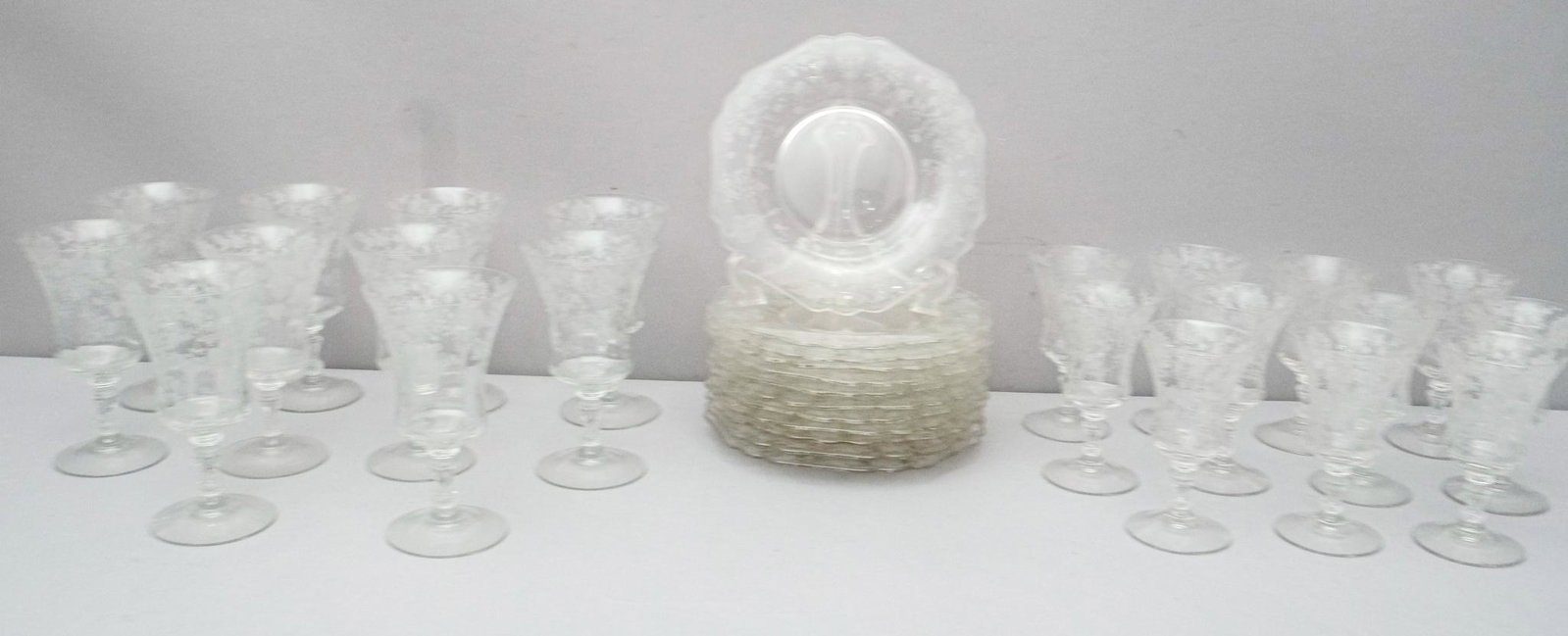 Large Set of Cambridge Rose Point Crystal: Consisting of ten wine glasses, eleven smaller cocktail glasses, as well as twelve sandwich plates. Wine glasses with a 3 1/2" diameter x 6 3/8" tall, Cocktail glasses 2 7/8" diameter x 5 3/8" tall, s