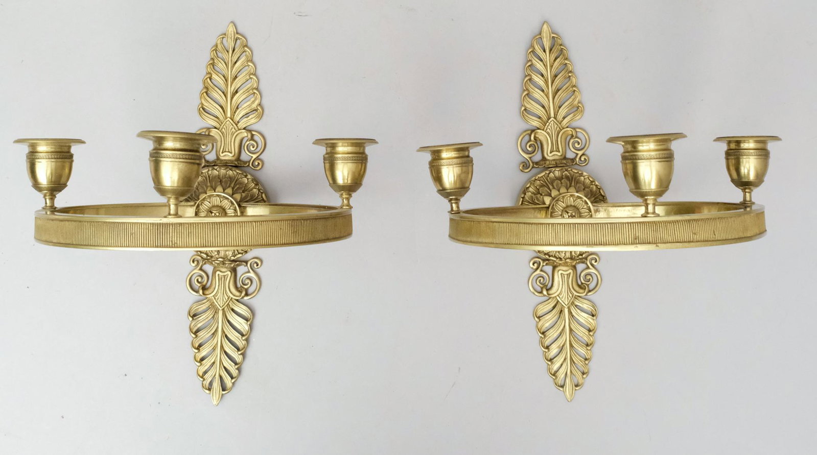 French Gilt Bronze Neoclassical Candle Sconces: Three sockets on hemisphere, backed and set with an acanthus medallion. Measure 12".