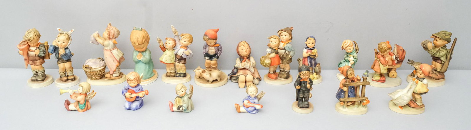 Lot of 19 Hummel Figurines: Various marks and depictions. A charming lot. 2 1/4" to 5 3/4".