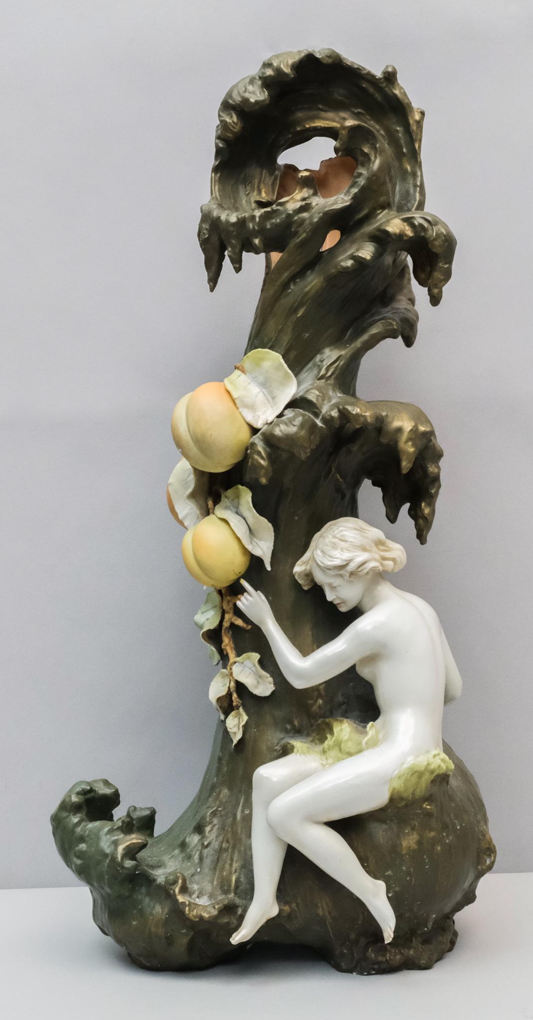 German Antique Art Nouveau Pottery Vase: Large figural Amphora style vase of a nude maiden amongst peaches and blossoms on a naturalistic green body. Marked as shown. 22 1/4".