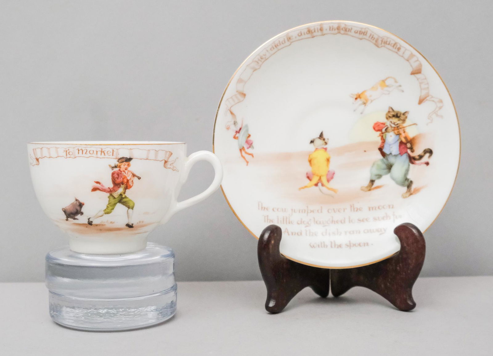 Royal Doulton "Nursery Rhymes" Cup & Saucer: Tea cup and saucer from Royal Doulton's "Nursery Rhymes" series. "To Market, to market to buy a fat pig, home again, home again jig a jig jig" cup together with "Hey diddle diddle, the cat and the fid