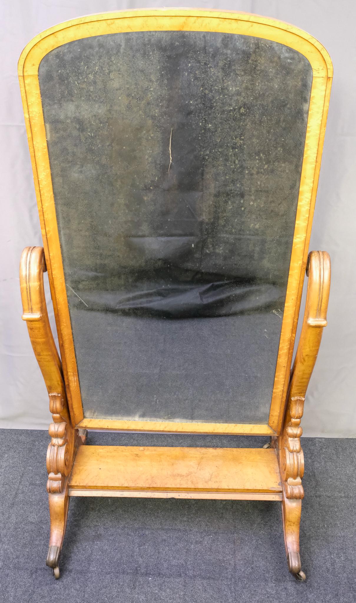 Antique Burlwood Cheval Mirror: Late 19th century cheval mirror with carved wooden stand, burlwood frame, on casters, 64" H x 28" W x 33 1/2" L.