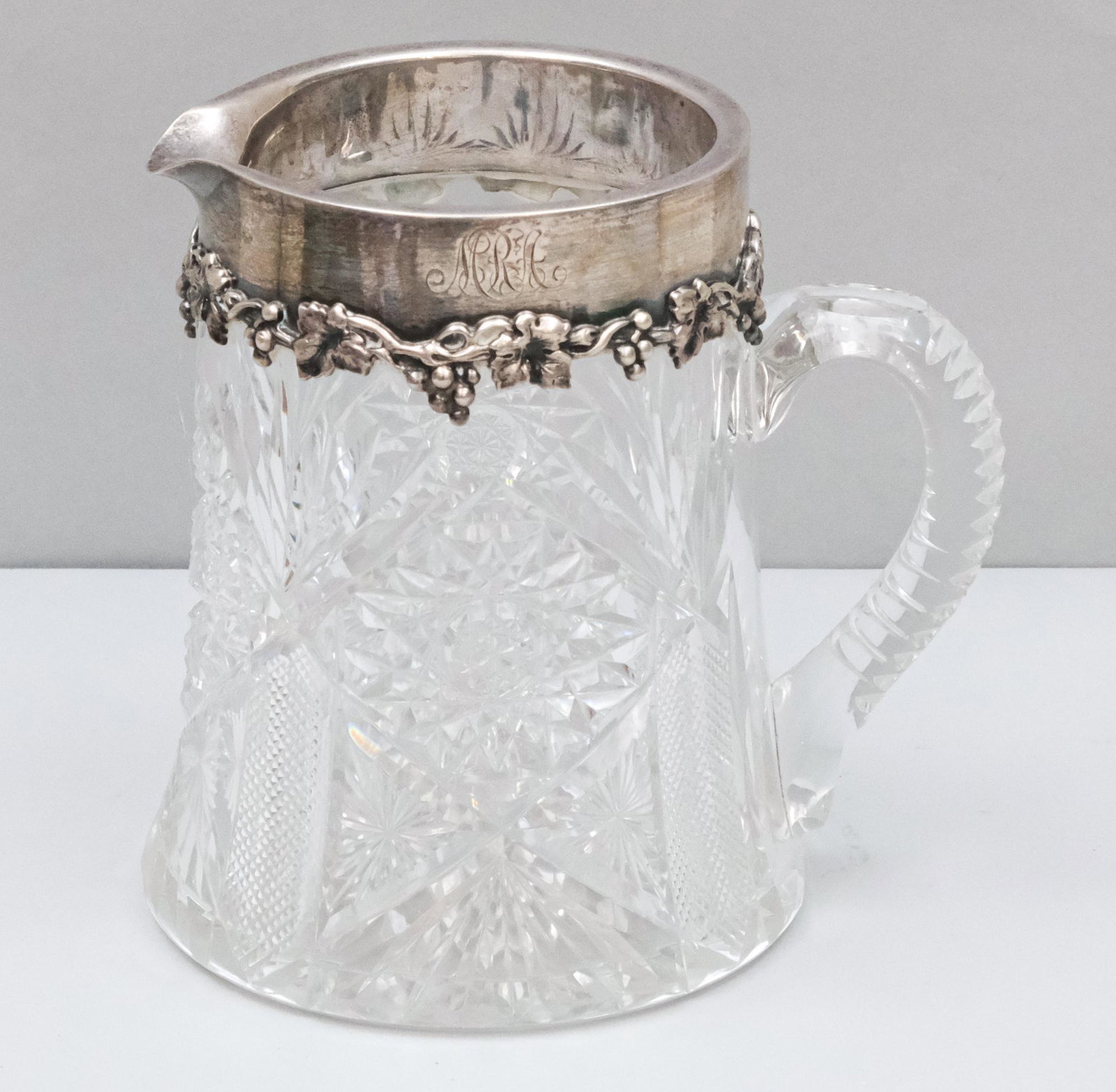 Dominick & Haff Sterling Cut Crystal Wine Pitcher: Lovely embossed grape collar, hallmarked and monogrammed as shown. Glass unmarked. 6 1/4" tall.