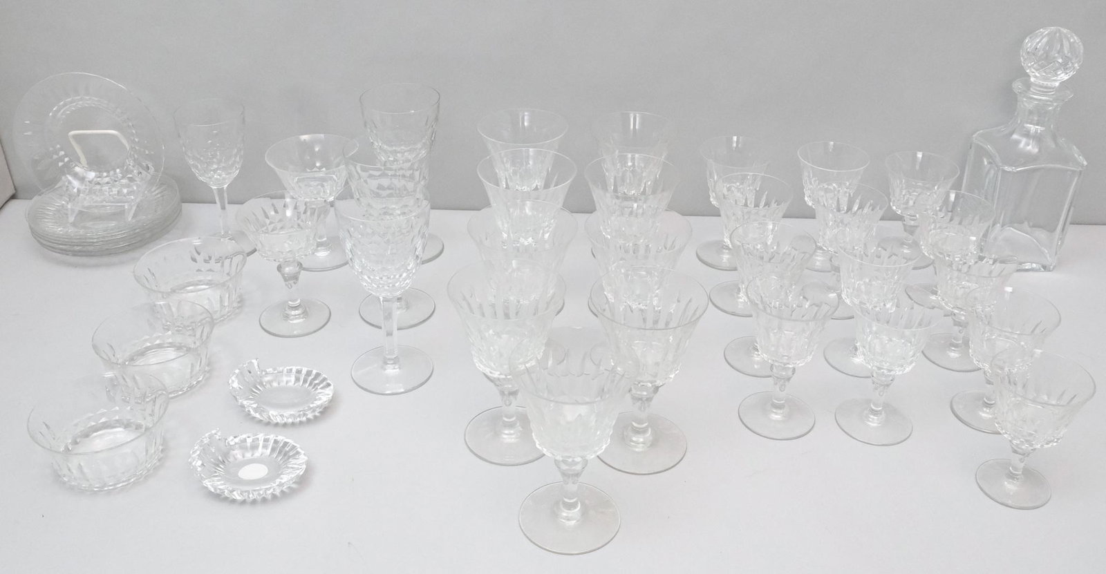 Lot of Baccarat Stemware & Other Articles: Lot consisting of various forms, all marked with Baccarat stamp, including faceted wine glasses, a decanter, ash trays, dishes, and many more.