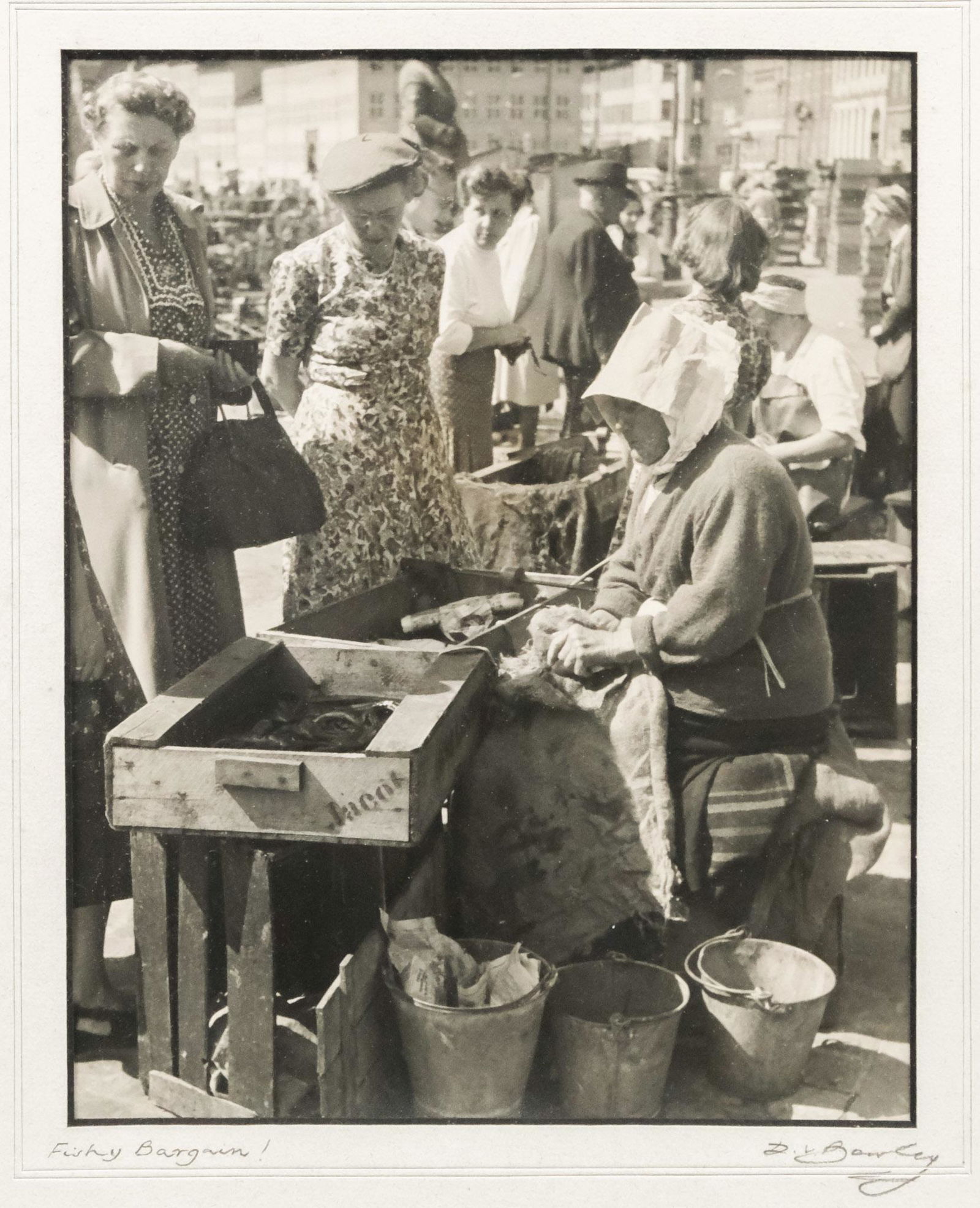 David Bowley, "Fishy Bargain!": David Bowley, early 20th century black and white photograph of women at a fish market, titled l.l., signed l.r., 7 1/2" x 9 1/2" sight, 11 3/4" x 14 3/4" framed.
