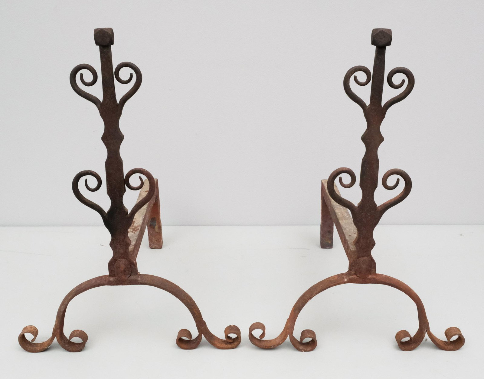 Pair of Arts & Crafts Andirons: Pair of 19th century wrought iron Arts & Crafts andirons with scrolled legs, 17 1/4" H x 12 1/4" W x 14" L.