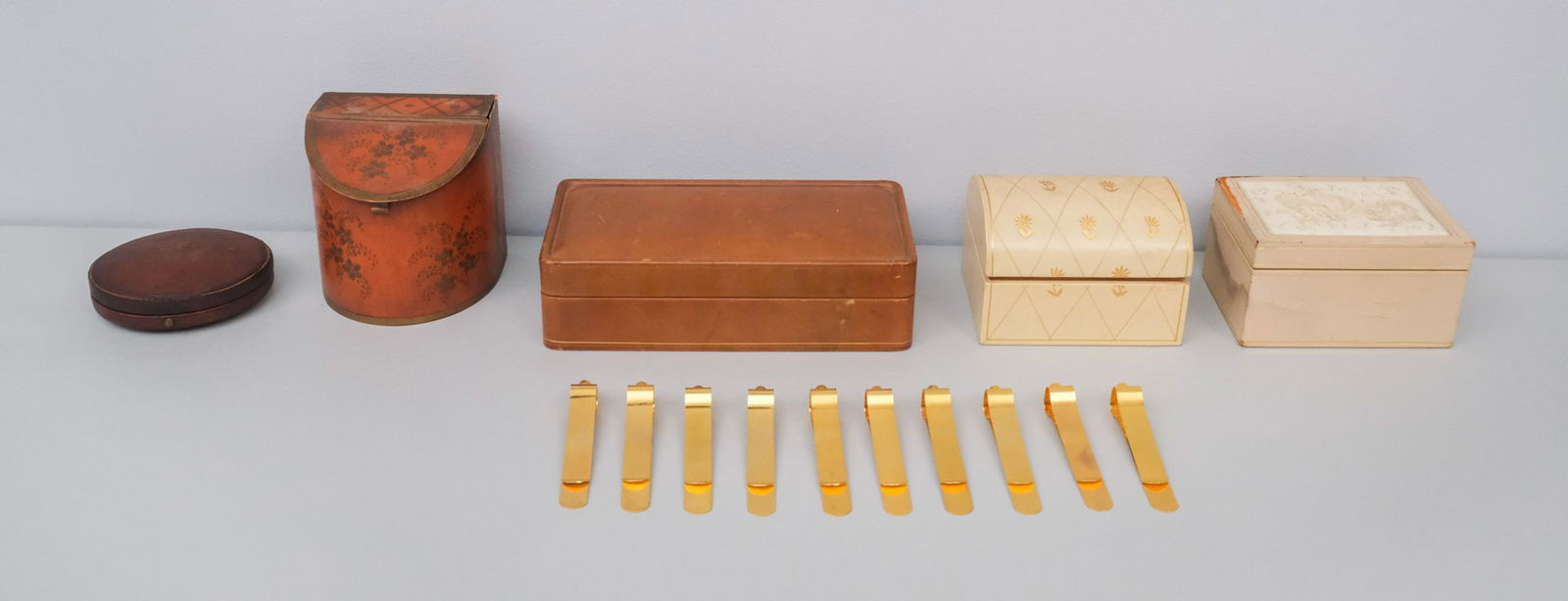 Lot of Antique & Decorative Boxes: Comprising a leather portrait miniature case, a gilt inlaid white leather dresser box, a knife box form example by James Patrick, a brown desk box, and a box inlaid with a carved bone panel depicting