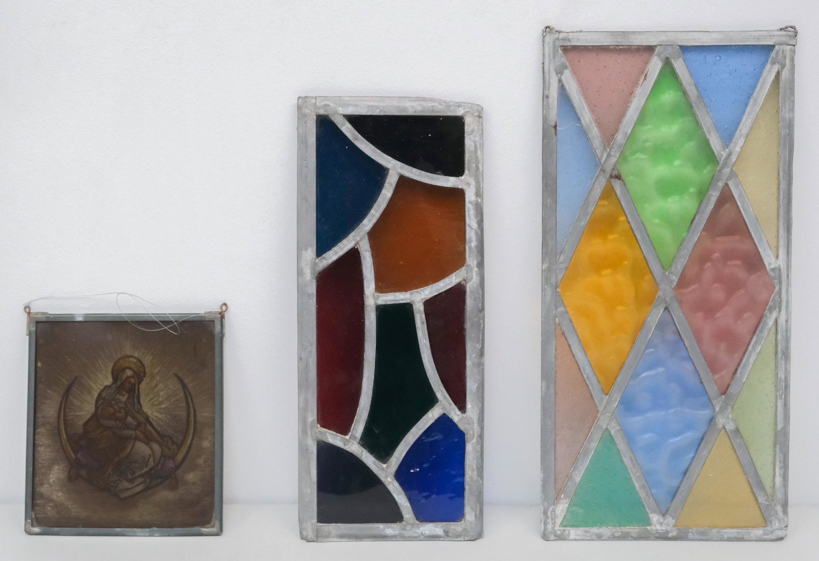 Lot of Antique Stained Glass Panels: Lot consisting of 1) brightly colored leaded glass segments in a panel, 5" x 12" overall; 2) brightly colored leaded bubble glass segments in a diamond pattern, 6 1/2" x 13 3/4" overall; and 3) a pain