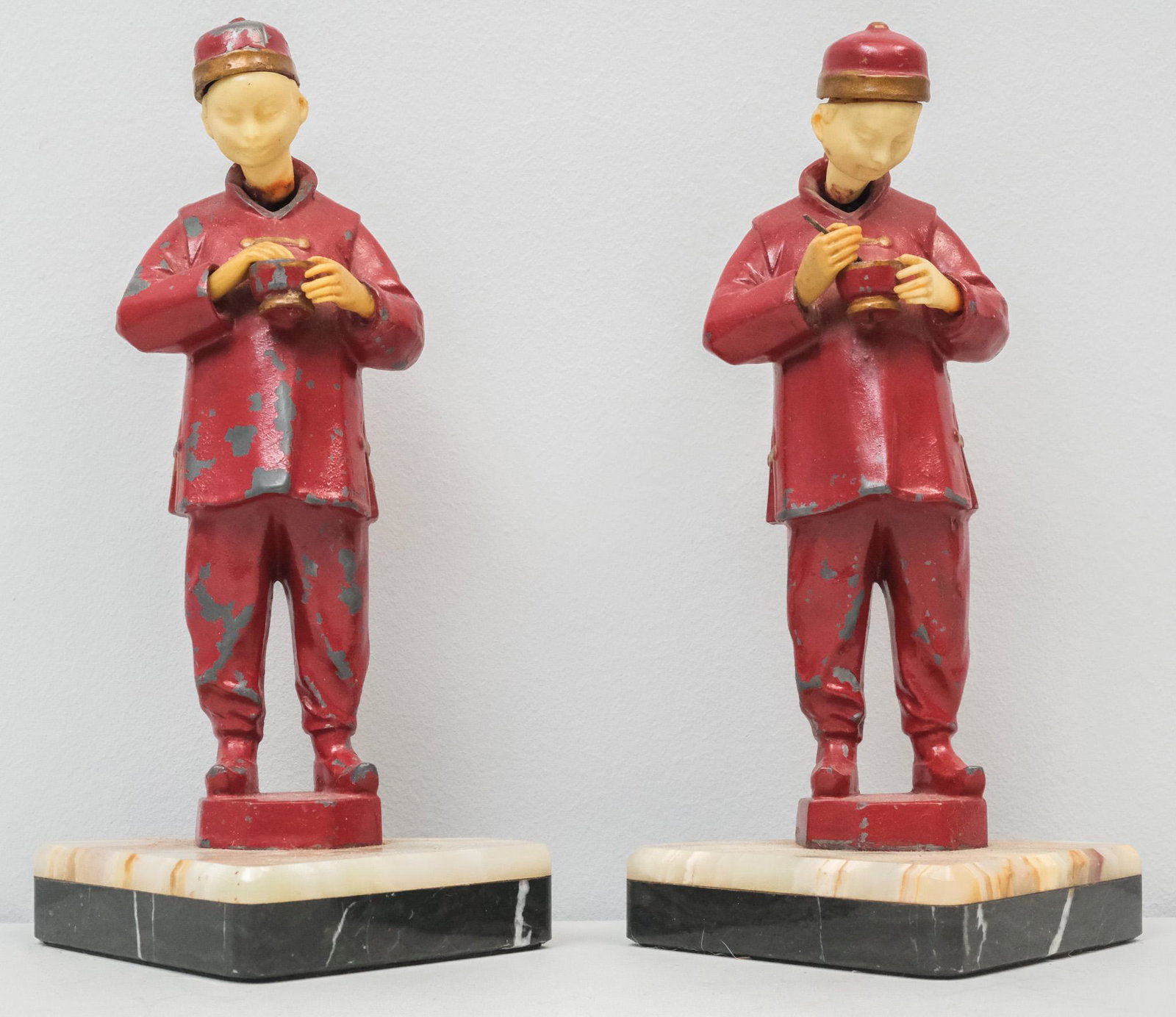 Pair of French Painted Metal Chinoiserie Bookends: Depicting figures eating and drinking. On onyx bases. 8 1/2"