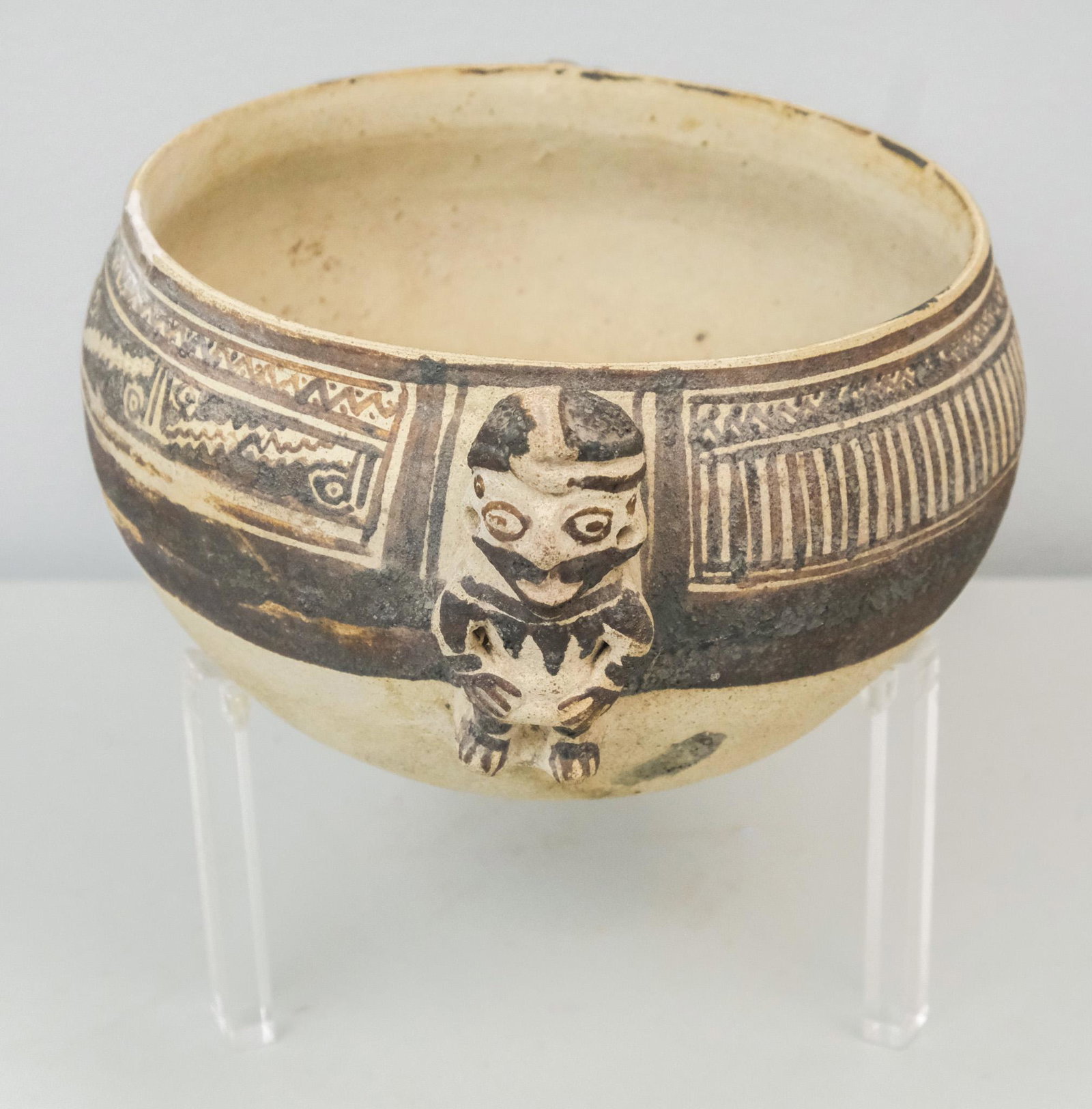 Vera Cruz or Pre Columbian Style Pottery Vessel: With painted geometric design and figural handle. On custom lucite base. 4" x 8 1/4".