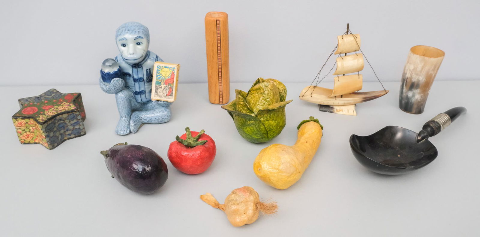 Lot of Decorative Objects: Lot consisting of 1) group of papier mache vegetables, 8" largest, 2 1/2" smallest; 2) carved horn ship model, 7" H x 6 1/2" W x 1 3/4" L; 3) carved bull horn cup, 5" H x 2 1/2" W x 2 1/4" L; 4) carve