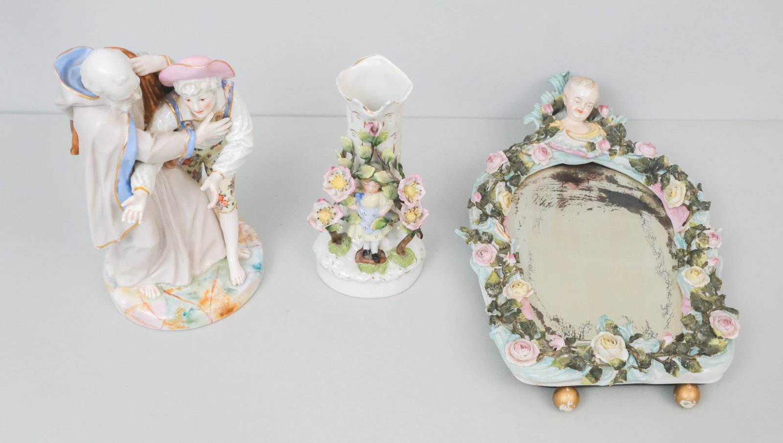 Miscellaneous Lot of Antique Figural Porcelain: Comprising a figural flower vase, a figural group with spurious Meissen mark, and a dresser mirror. Mirror 15" tall.