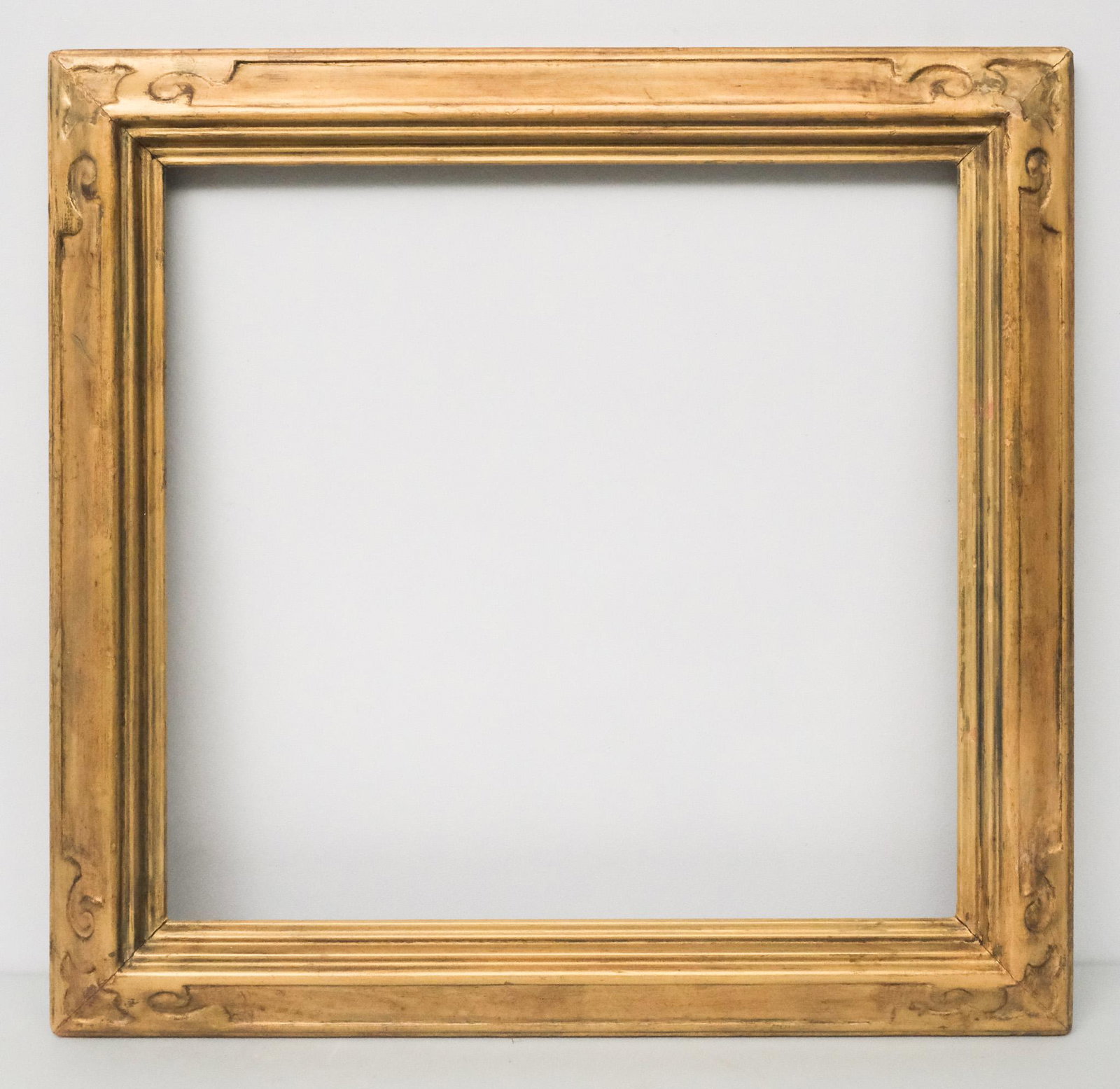 American Arts & Crafts Gilt Frame: American, circa 1920, hand carved and gilded with art nouveau elements. Overall 25 3/4" x 26 1/2", rabbet 20" x 21", molding 3".