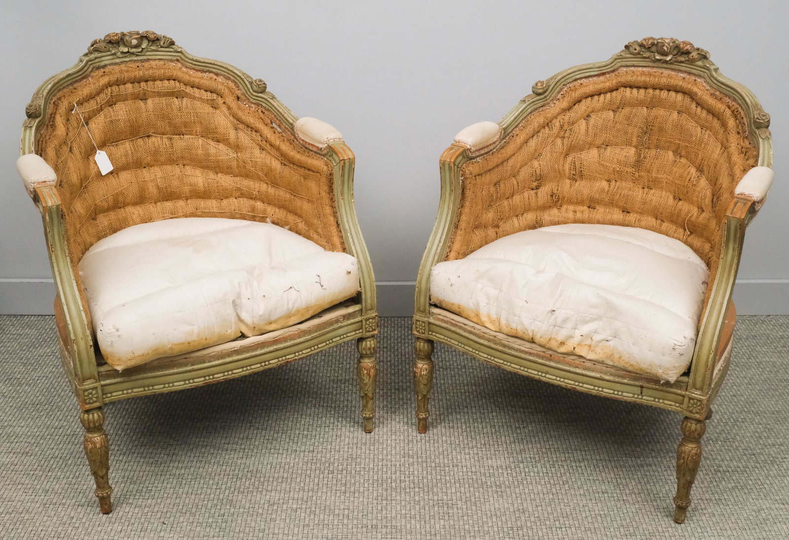 Pair of French Tub Chairs: French, 19th century tub chairs with carved frame, floral decorations along back and arms, unupholstered, 35 1/4" H x 27" W x 22" L.