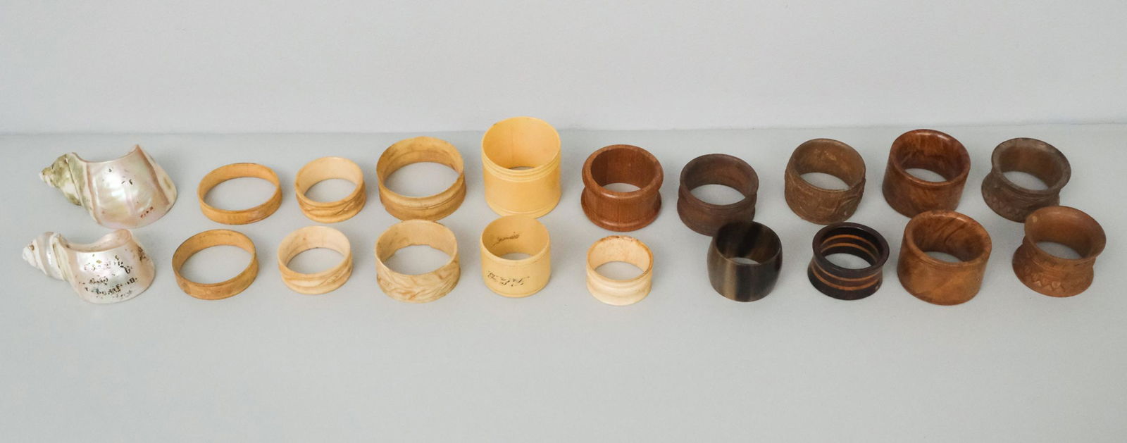 Mixed Lot of Napkin Rings: A variety of finely carved and crafted shell napkin rings including wood, bone, plastic, horn. Lot includes Treenware and Sailor's carved Napkin Rings