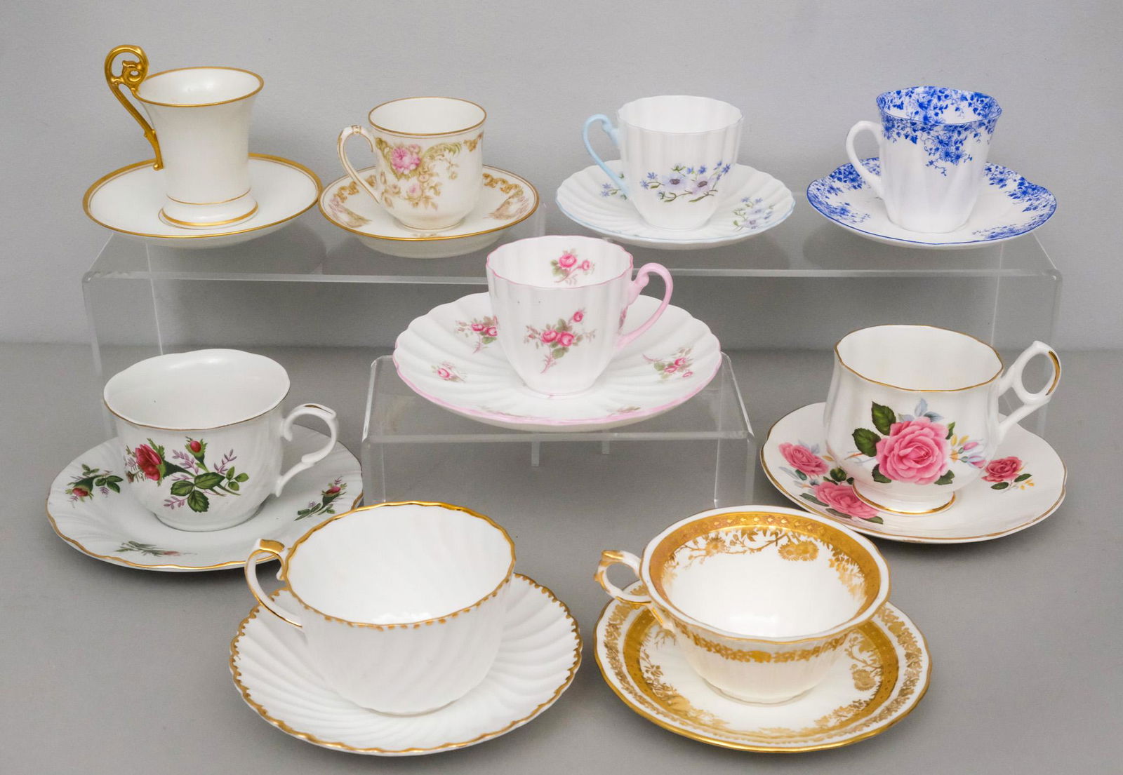 Lot of Fine Porcelain Tea Cups Including Shelley: Comprising 3 by Shelley in the "Dainty Blue", "Bridal Rose", and "Blue Rock" patterns, together with 6 others including Wedgwood and Lynn's.