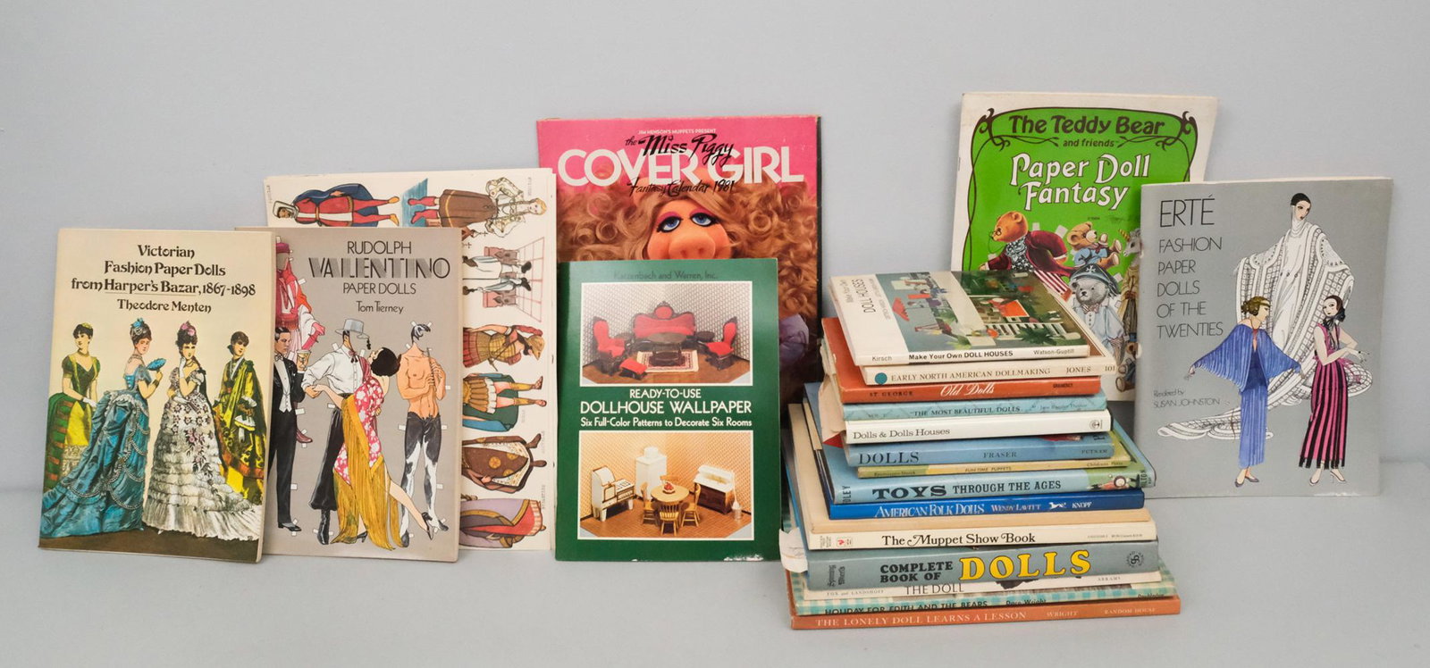 Lot of Doll Related Books and More: Included are books on doll identification, doll making, dollhouses, and doll history. Also included is a book about the Muppet Show, a Miss Piggy 1981 Fantasy calendar, several paper doll books and do
