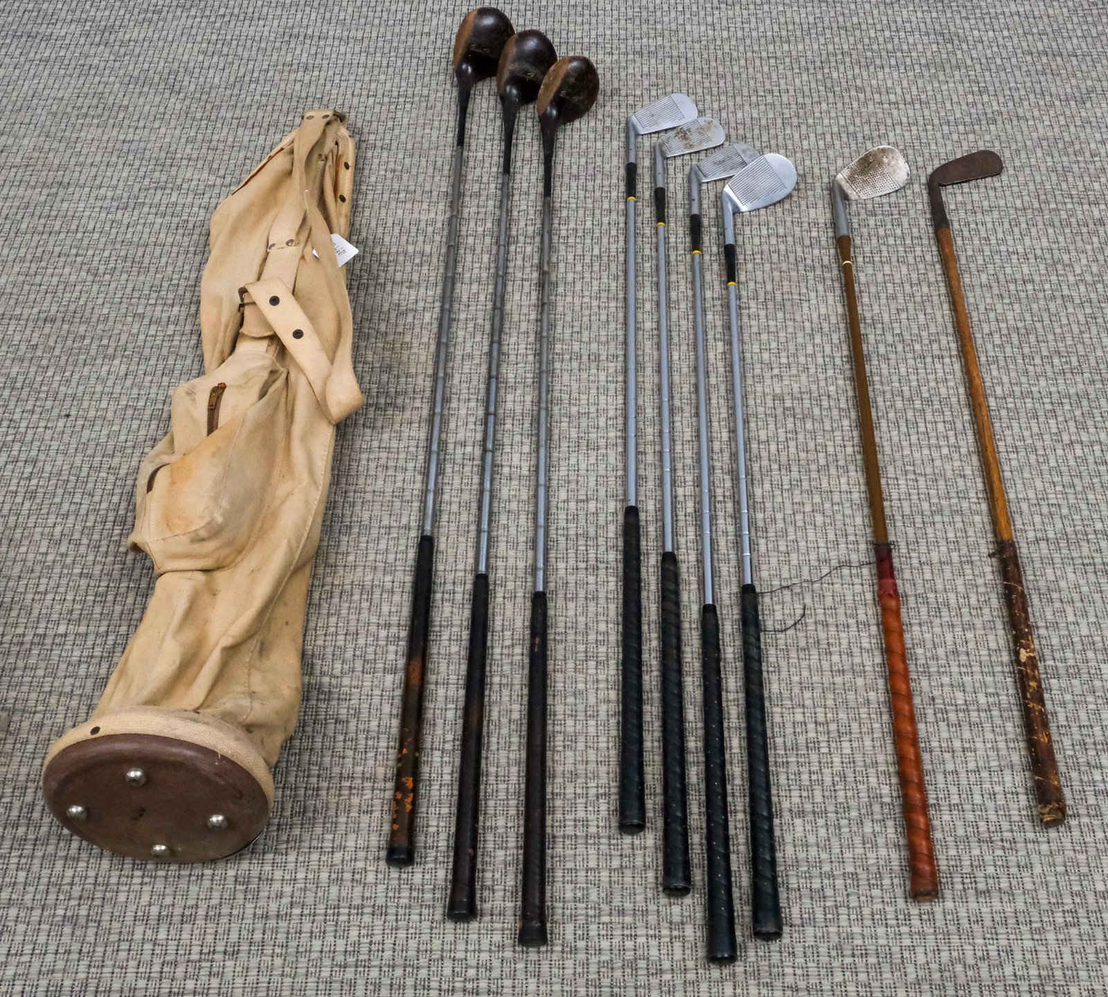 Set of Vintage Golf Clubs: Comprising a Walter Hagen Ambassador 2, 3, 4, and 6 Iron. A Henry Cotton 8-Iron, an Abercrombie & Fitch putter with wooden shaft, and a Spalding 1,2, and 3 wood in canvas bag