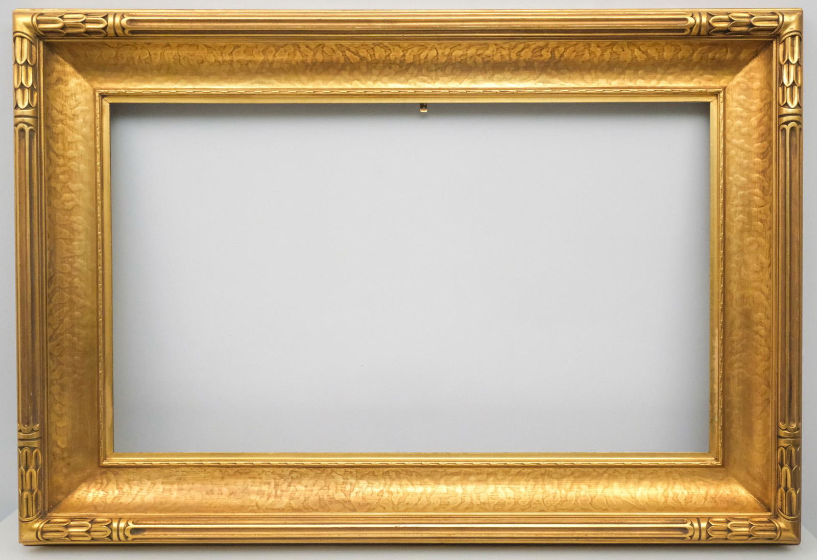 American Arts & Crafts Gilt Frame: American, circa 1910, hand carved and gilded frame with immense cove, possibly by Newcomb Macklin. Overall 36 3/4" x 54 3/4", rabbet 25" x 43", molding 6 1/4".