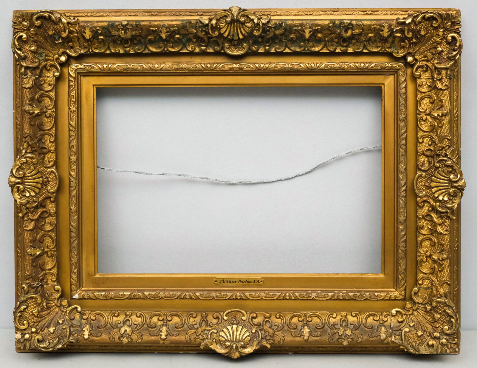 Louis XIV Giltwood Frame 12" x 18": American, circa 1880, gilded frame in the French style, bears name plate for Arthur Parton. Overall 21" x 27", Rabbet 12" x 18", Molding 5"