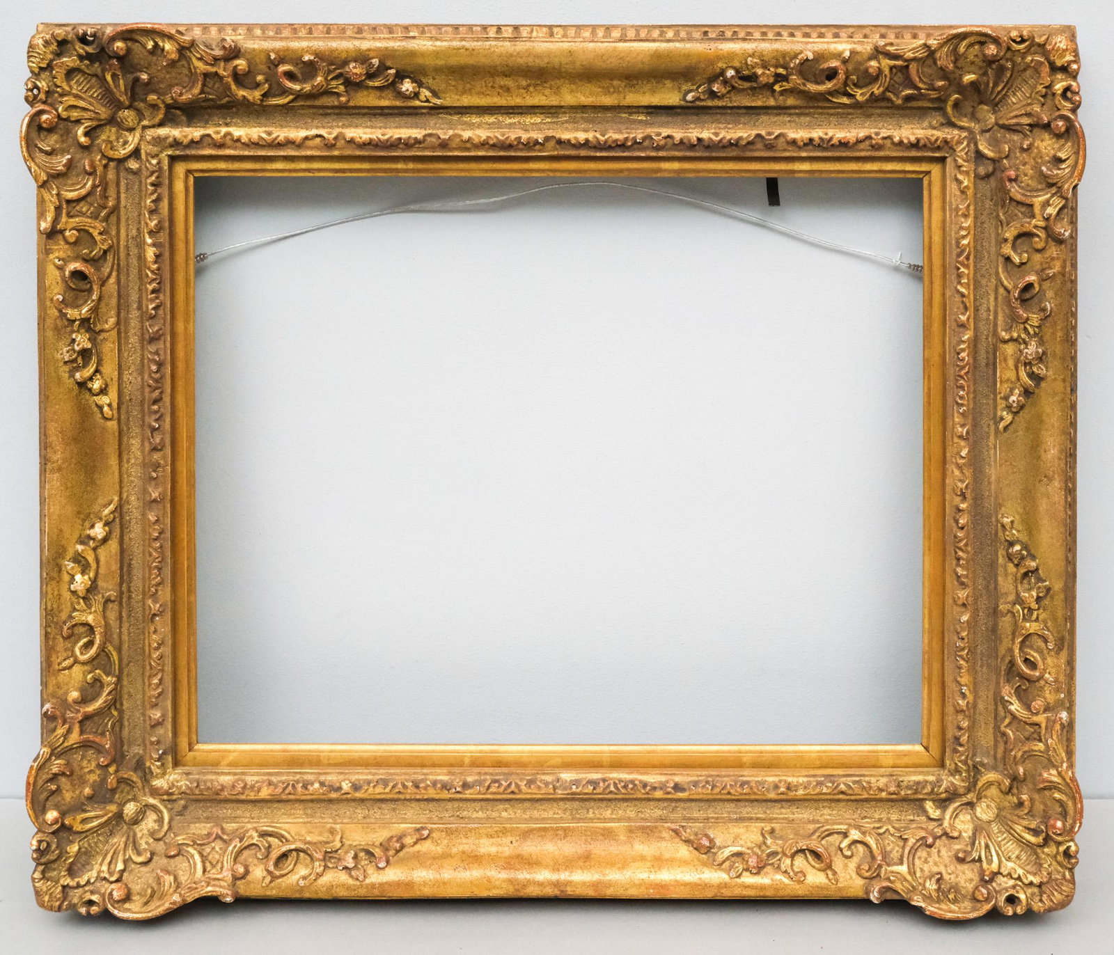 Louis XIV Giltwood Frame 12 1/2" x 15 1/2": American, 20th century, a very finely wrought custom Louis XIV style carved frame. Overall 18" x 20 1/4", Rabbet 12 1/2" x 15 1/2", Molding 3"